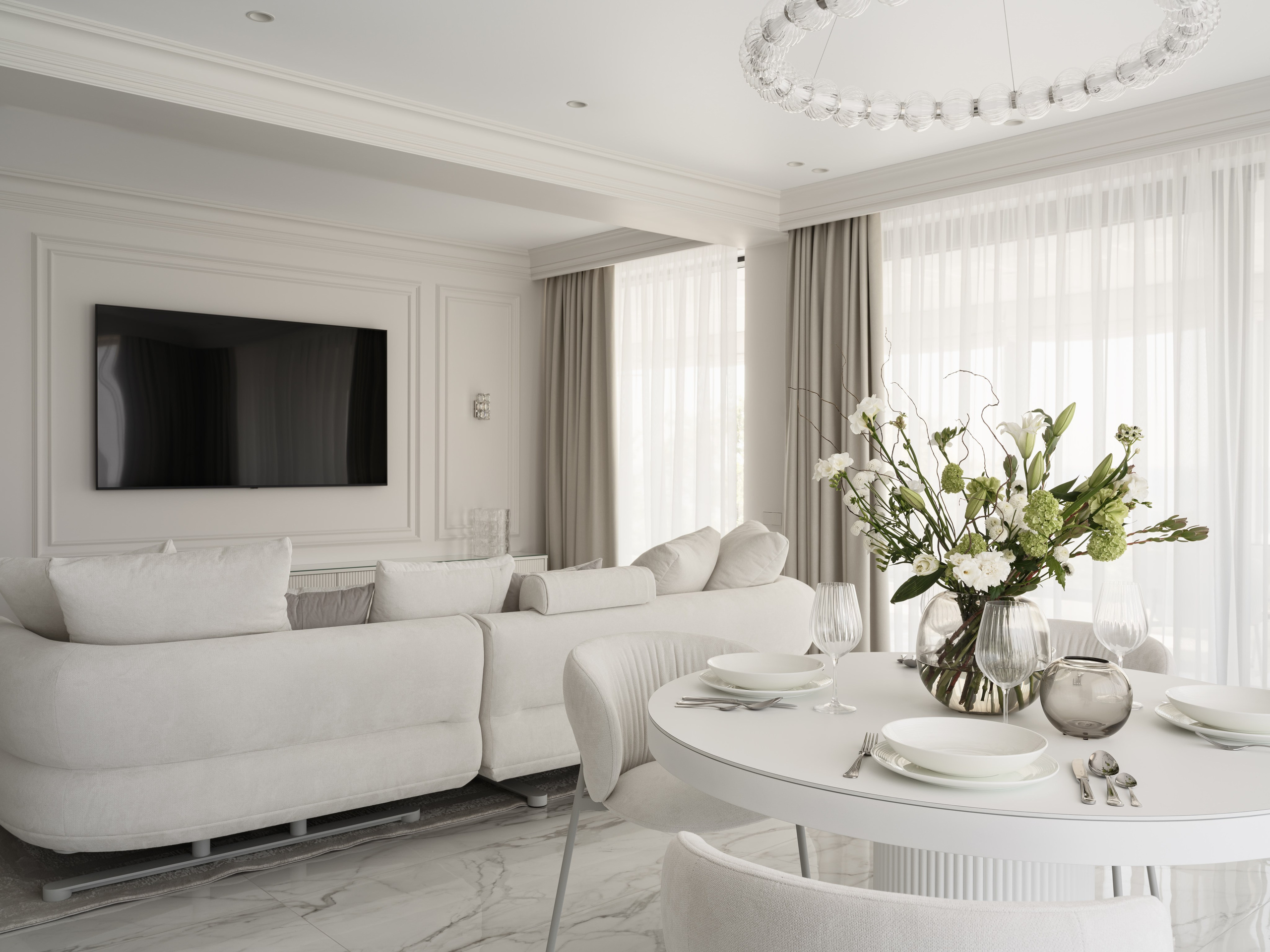 Современная гостиная-столовая в светлых тонах с дизайнерской мебелью, мягким диваном и круглым столом, оформленная дизайнером Алёной Боярской, стилизована Натальей Якушевой и запечатлена фотографом Сергеем Денисенко — изысканный интерьер с акцентом на естественный свет.