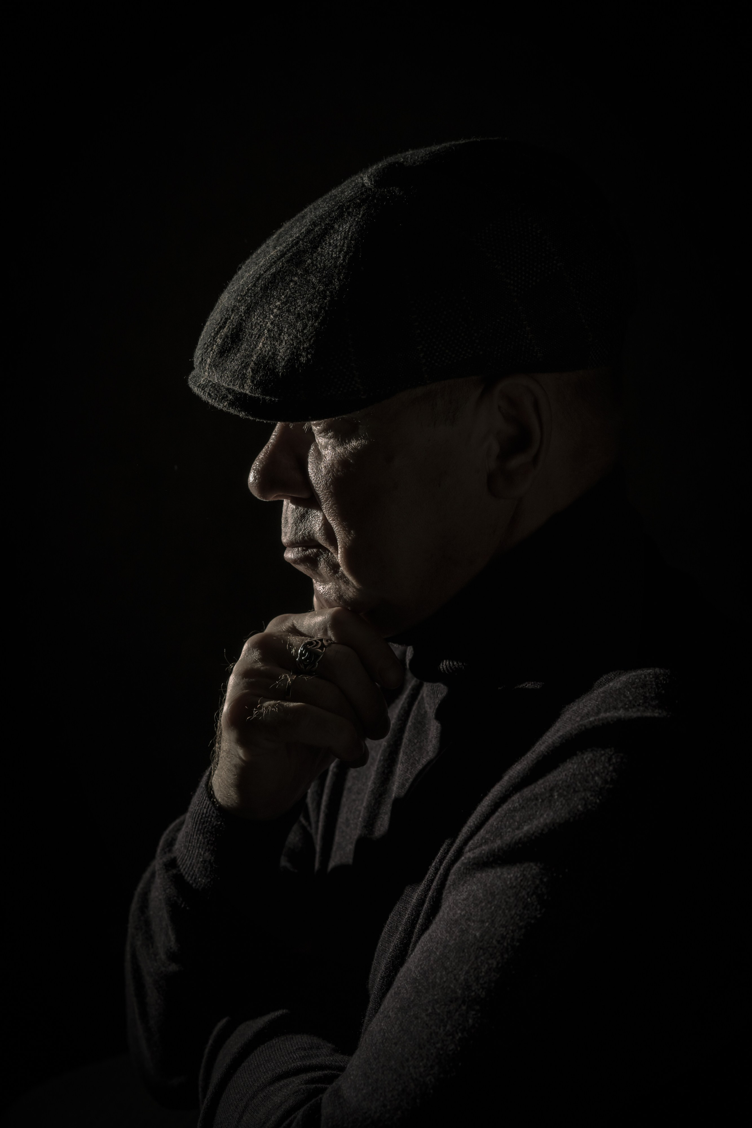 деловой мужчина, выразительный взгляд, уверенная поза, тёмный фон, идеально подходит для корпоративных страниц.