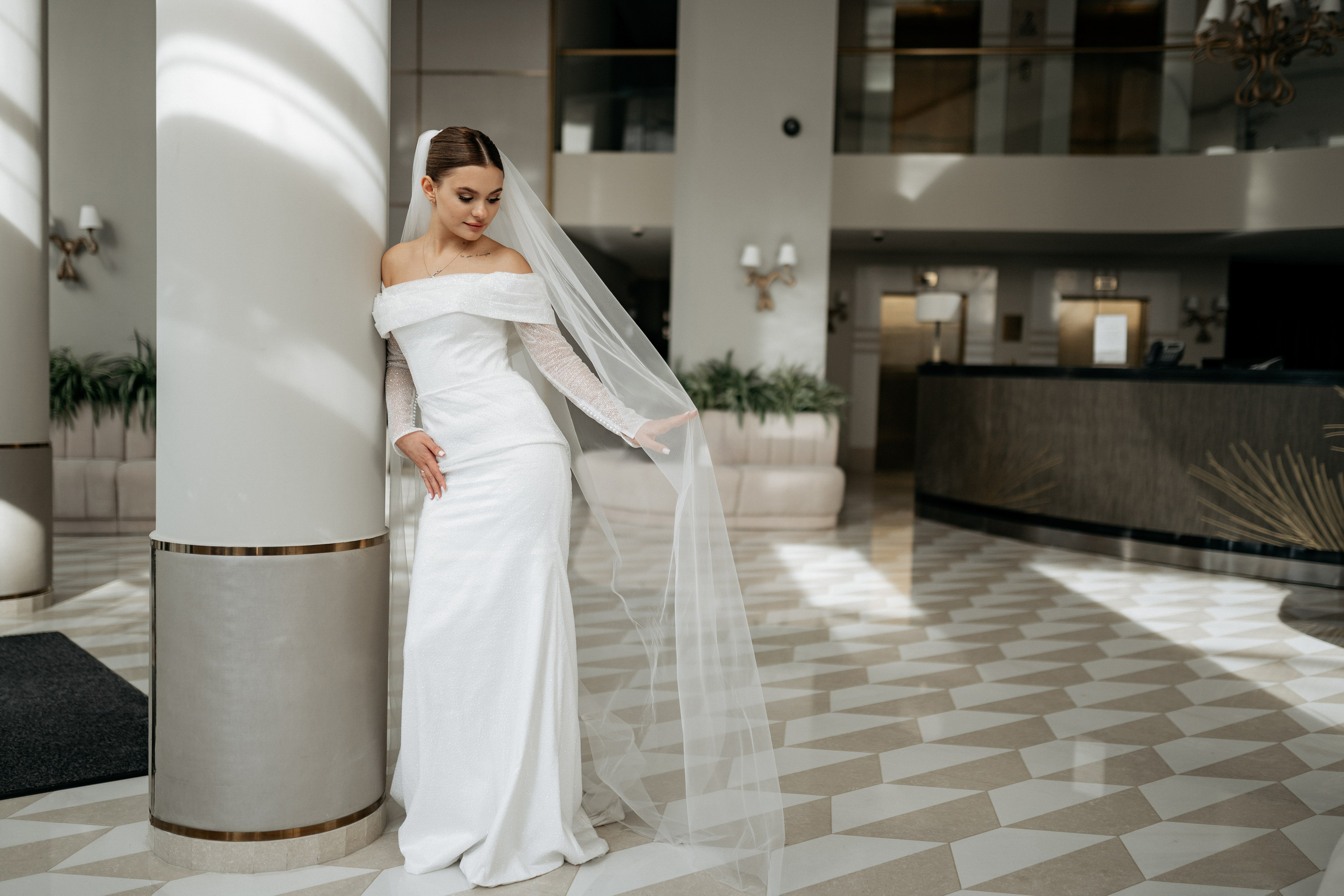 Невеста поправляет фату – нежный момент, свадебная фотография, сделанная свадебным фотографом из Геленджика