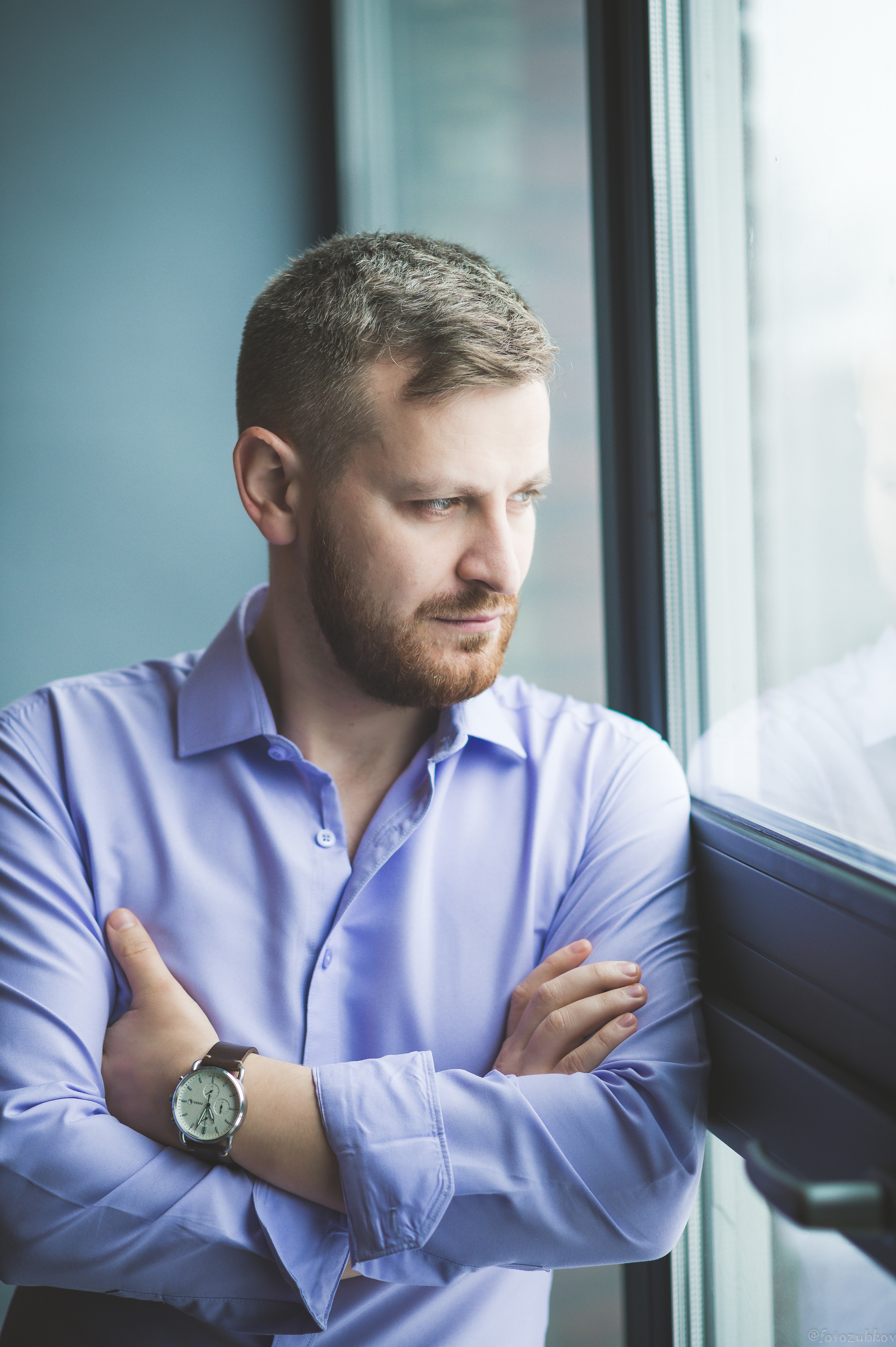 Серьёзный взгляд молодого человека смотрящего в окно