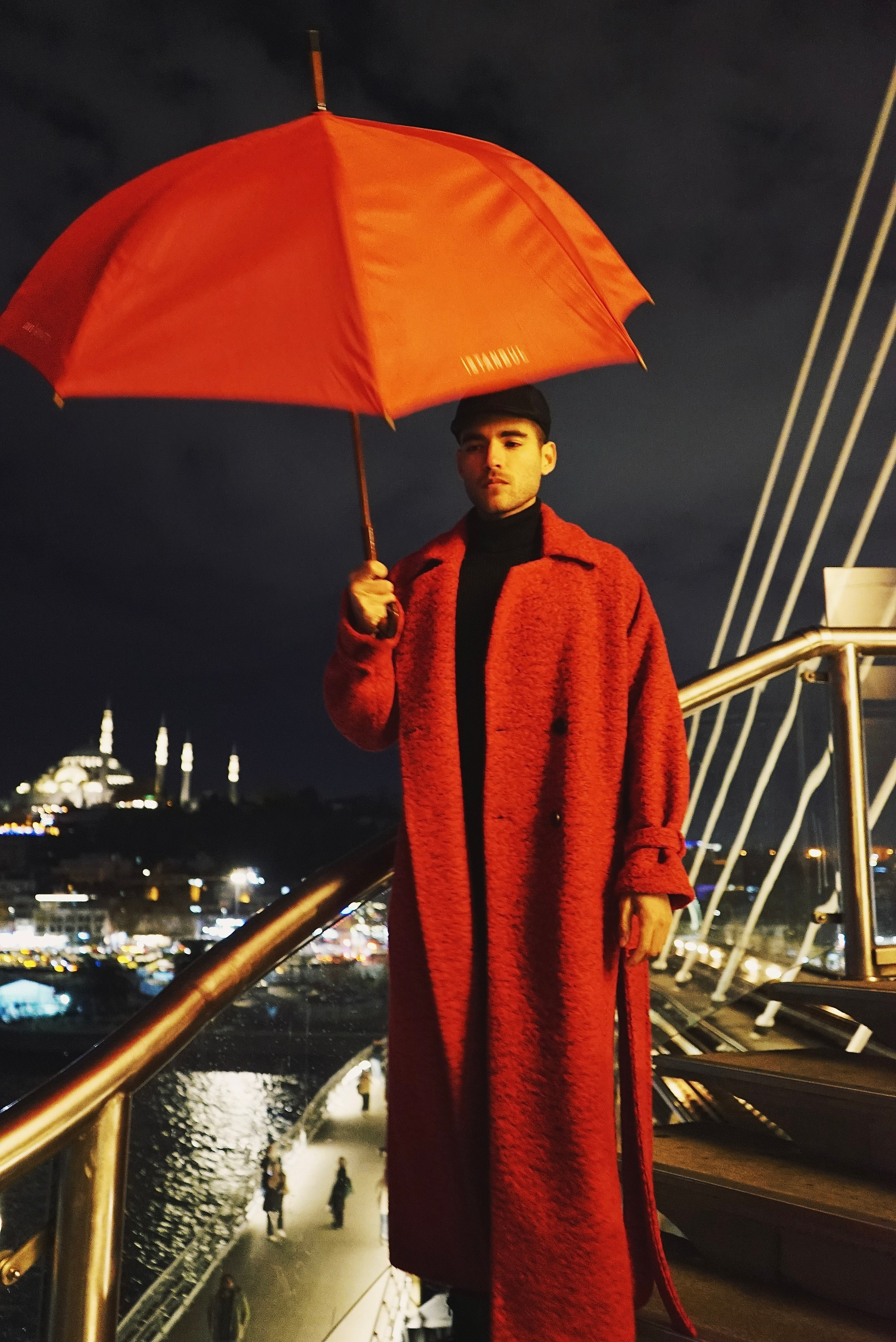 Night photoshoot in Istanbul with a red umbrella.