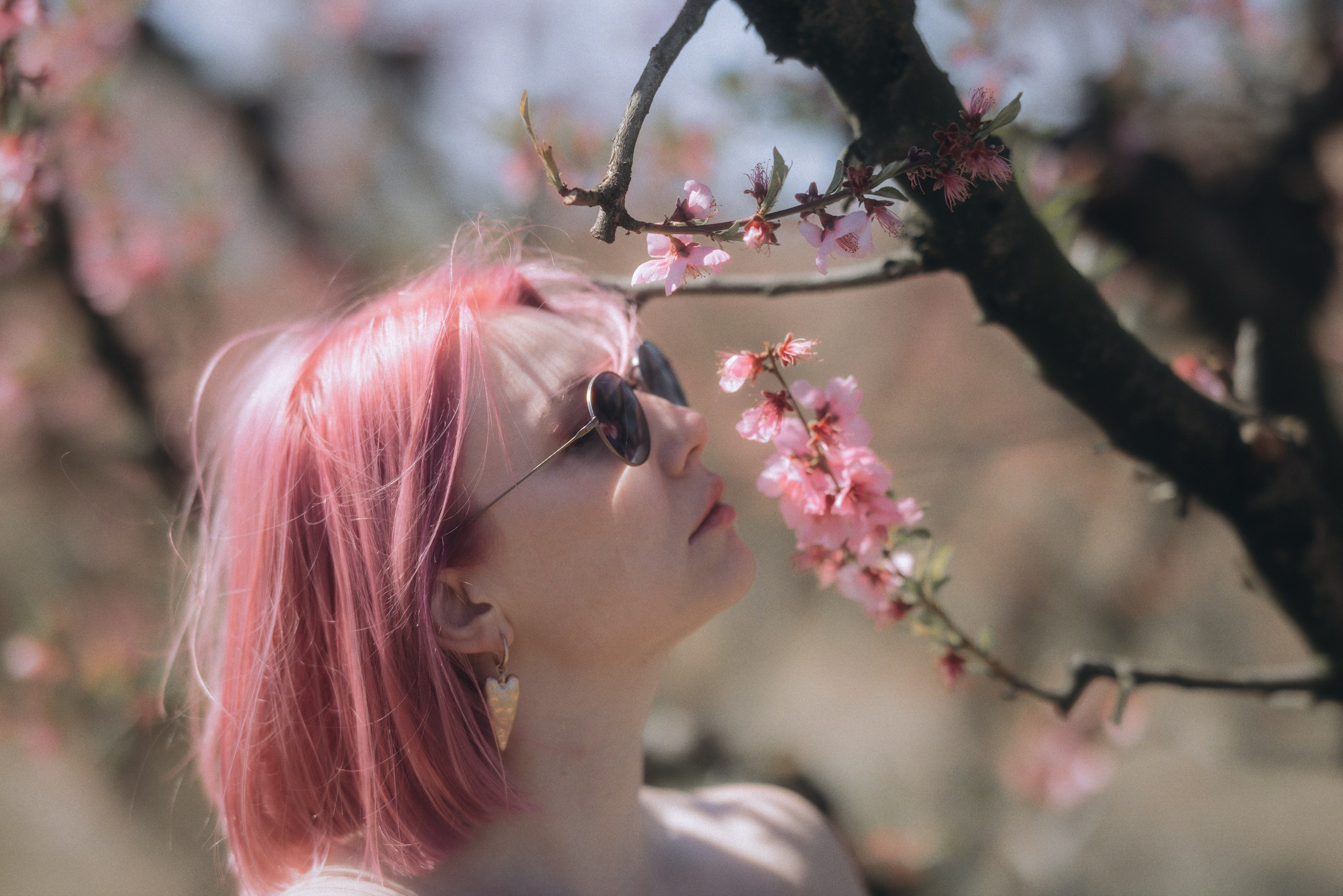 Romantic photoshoot of a woman in a blooming garden in Barcelona with soft light