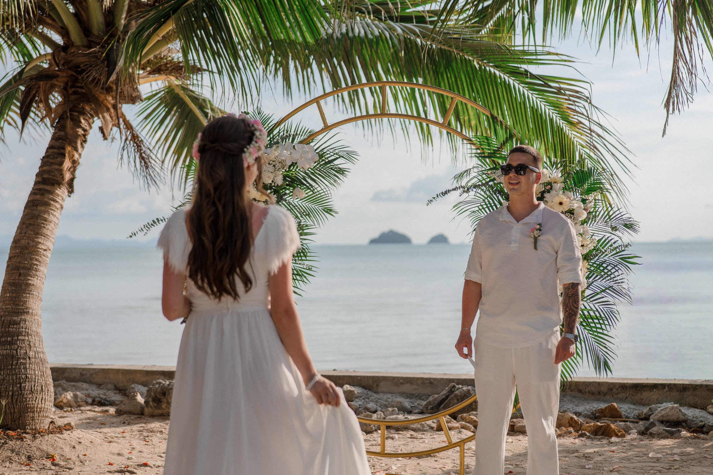 Bride and groom exchanging vows on a private sunset beach
