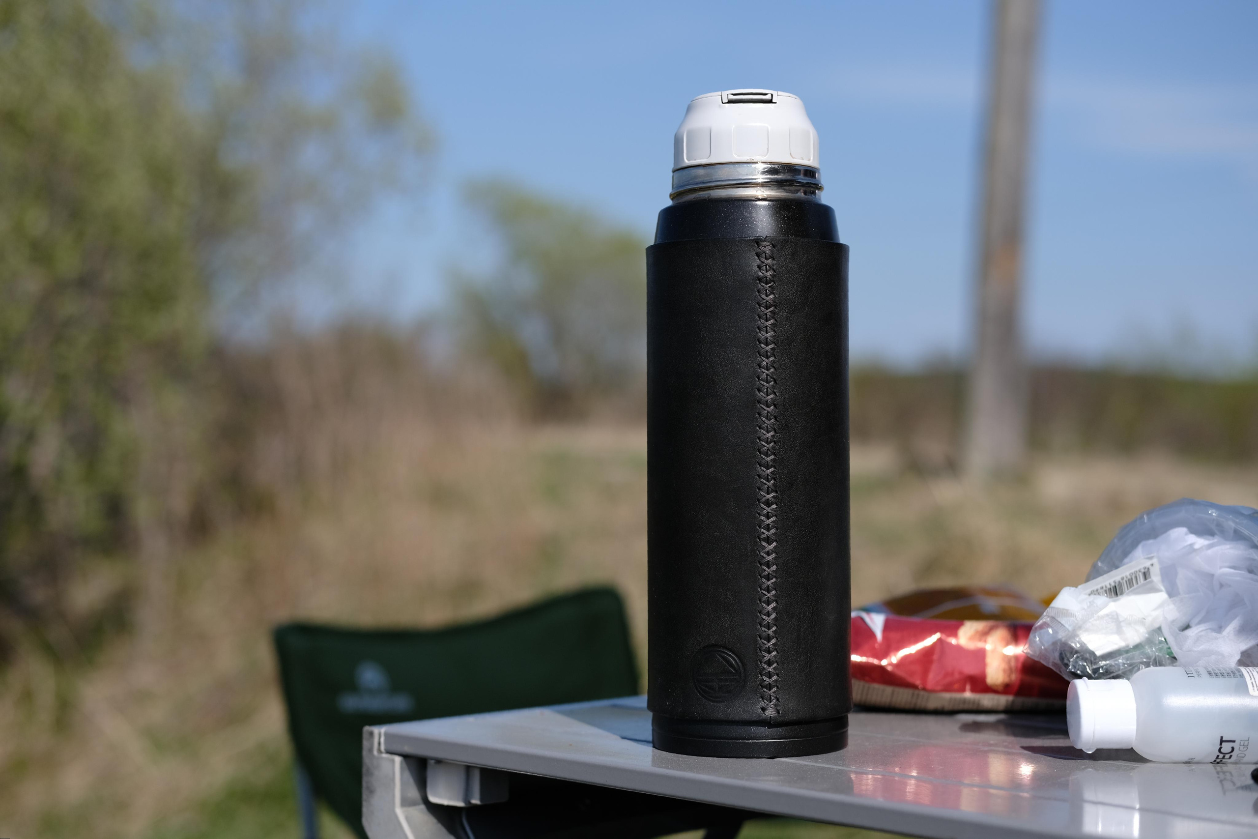 Cross-stitched thermos case made of 2 mm black leather, covered with finish gloss after six month of use.