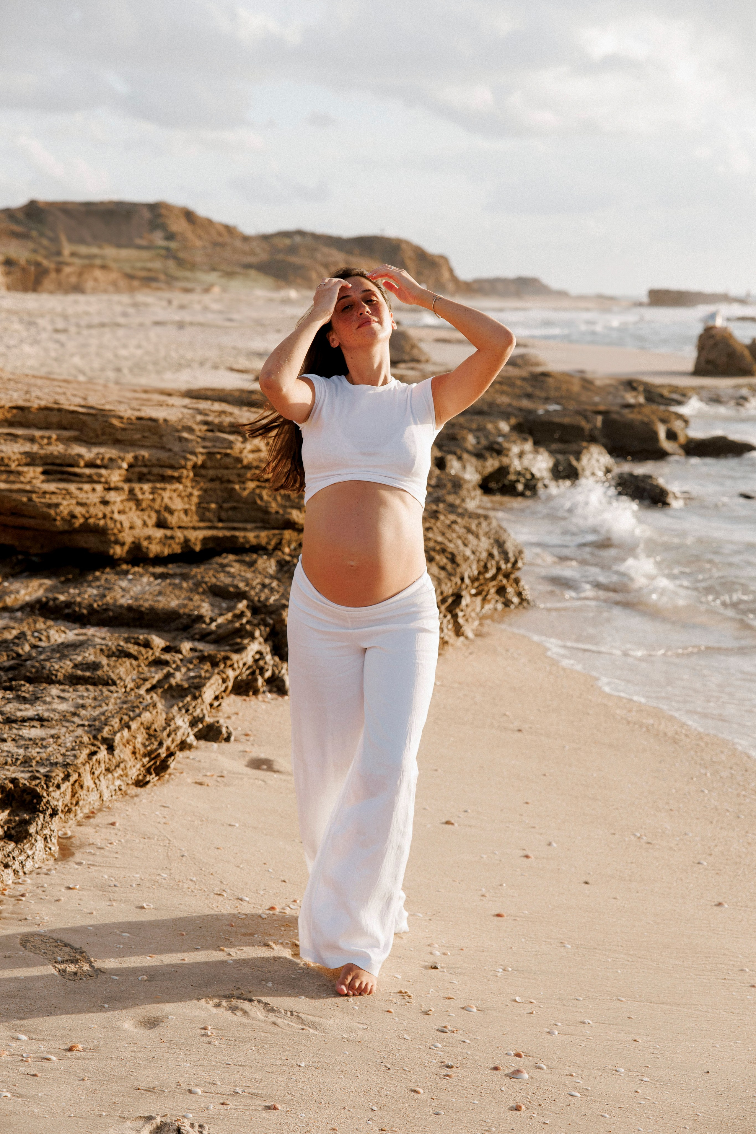 Pregnancy photoshoot near the sea. Wedding and family photographer