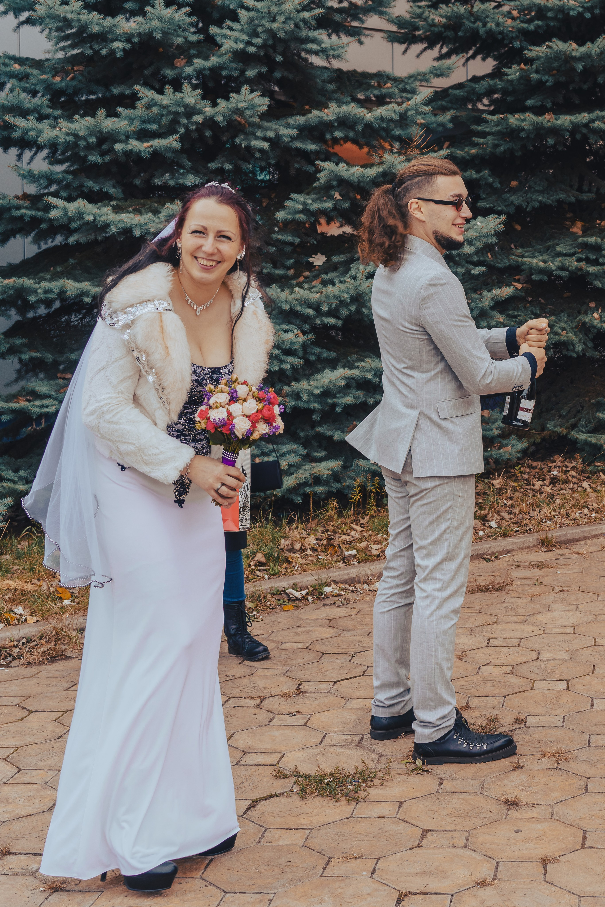 жених открывает шампанское, невеста смеется