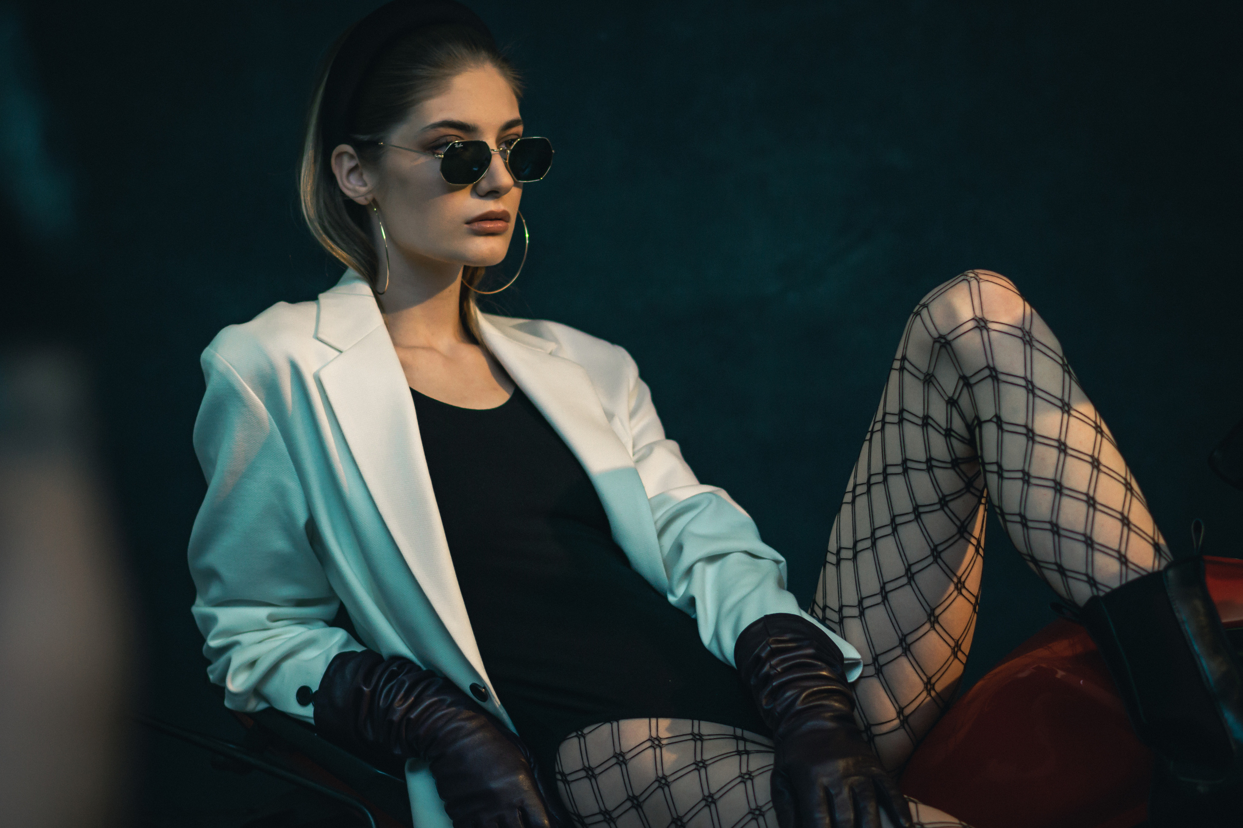 Девушка в белом пиджаке, чулках и в очках