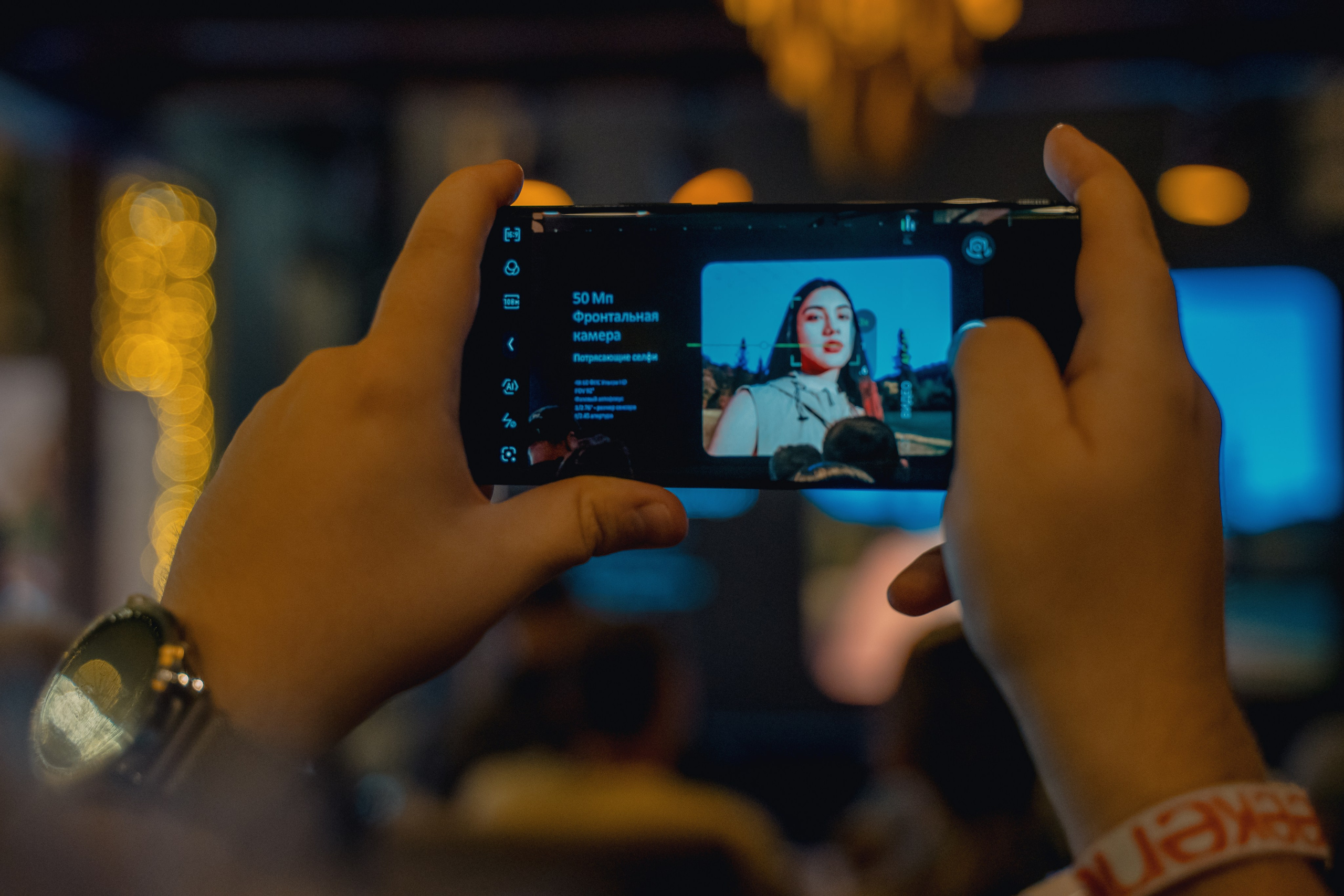 Фото как один из участников на телефон фотографирует презентацию 