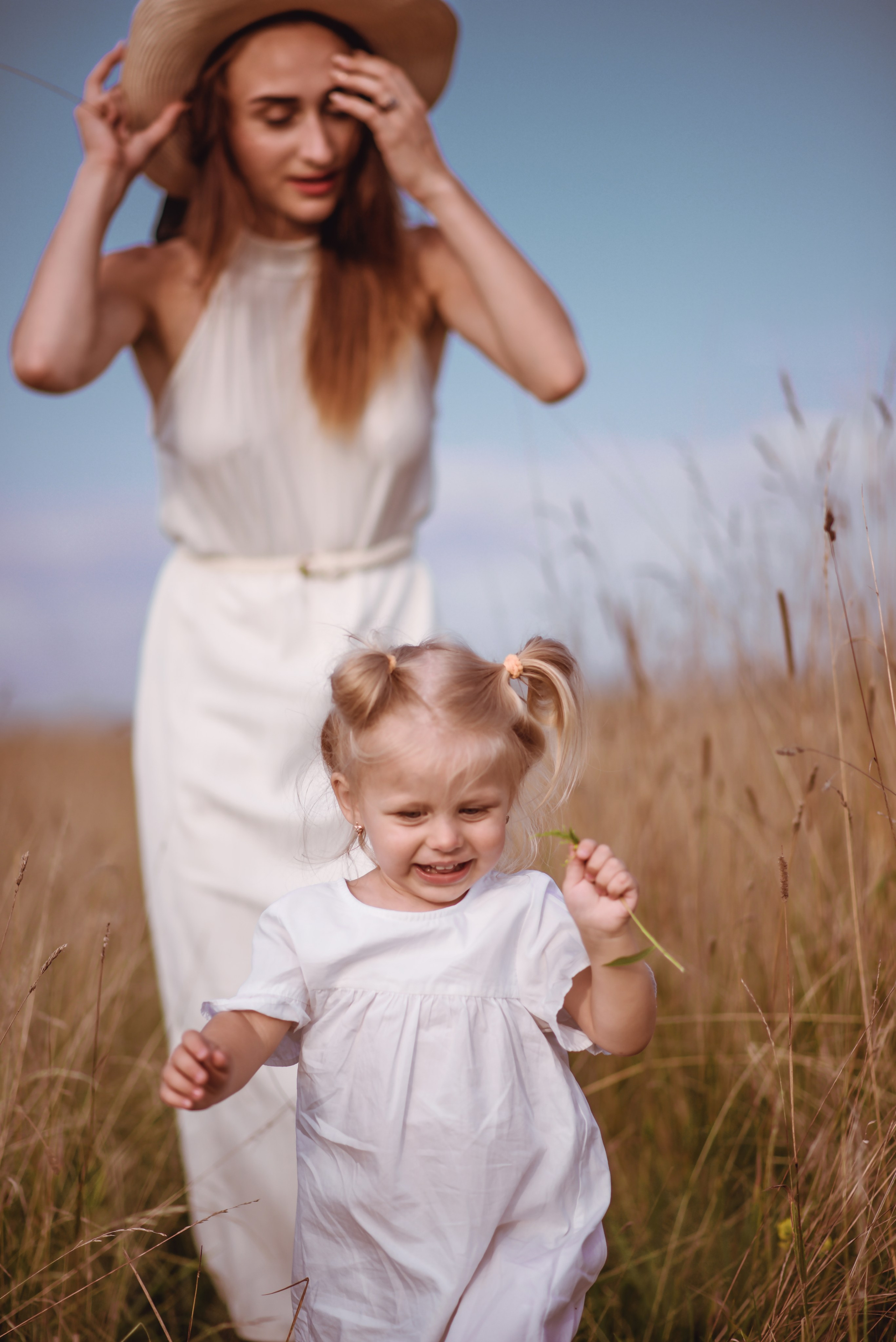 Mom walking with her children in a meadow