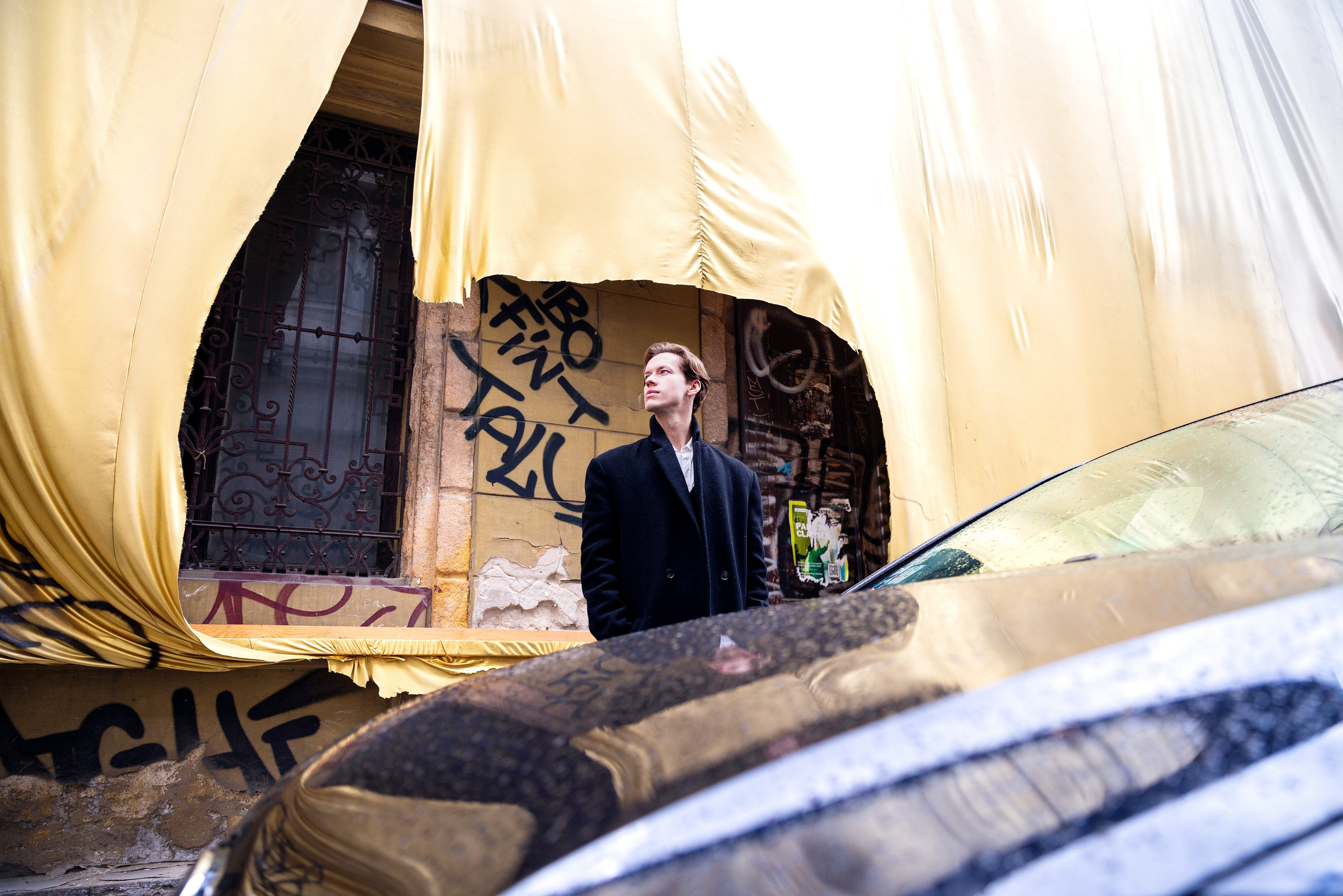 a photograph of a man on the streets of Budapest on a golden background