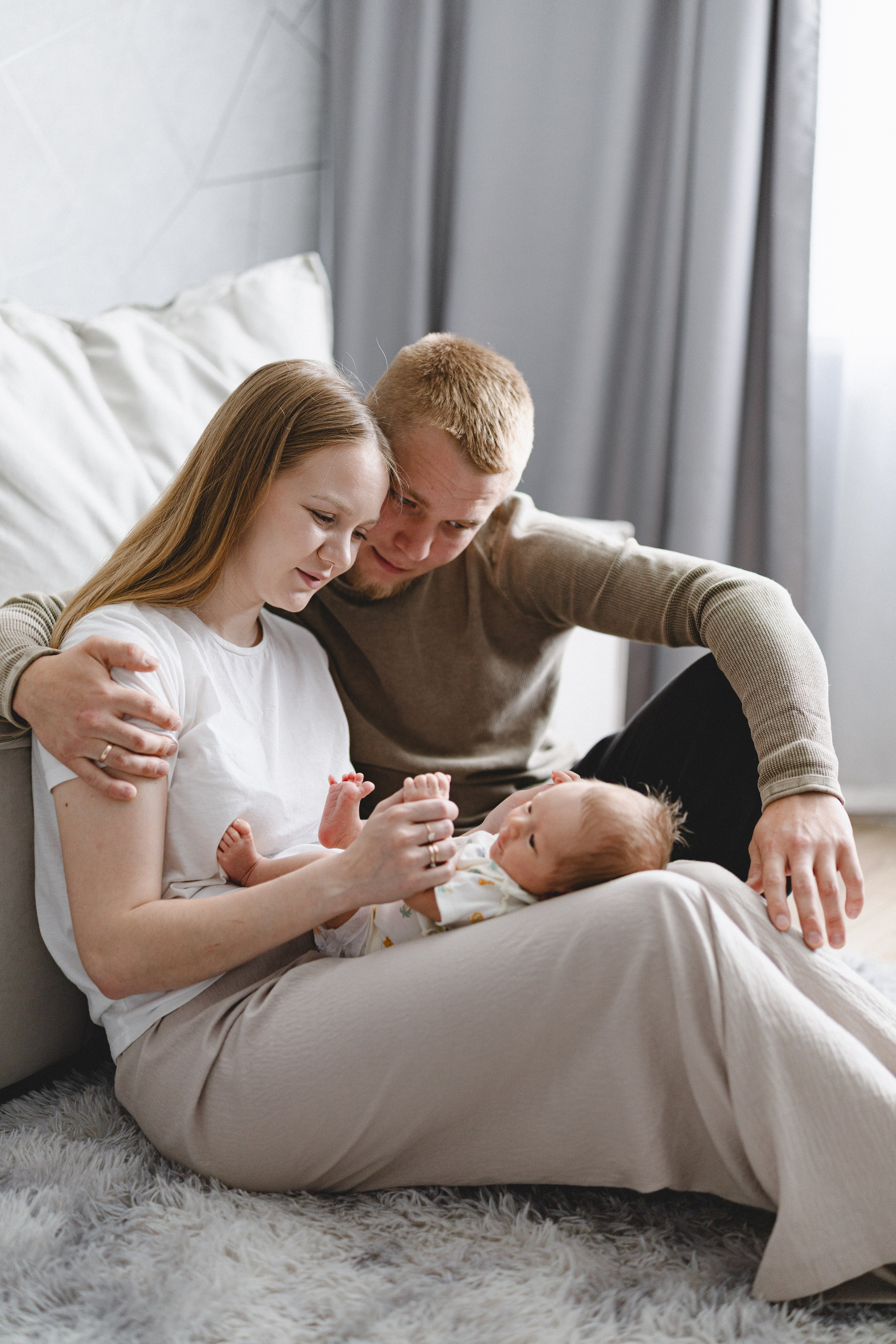 Parents sitting together on the floor with their baby