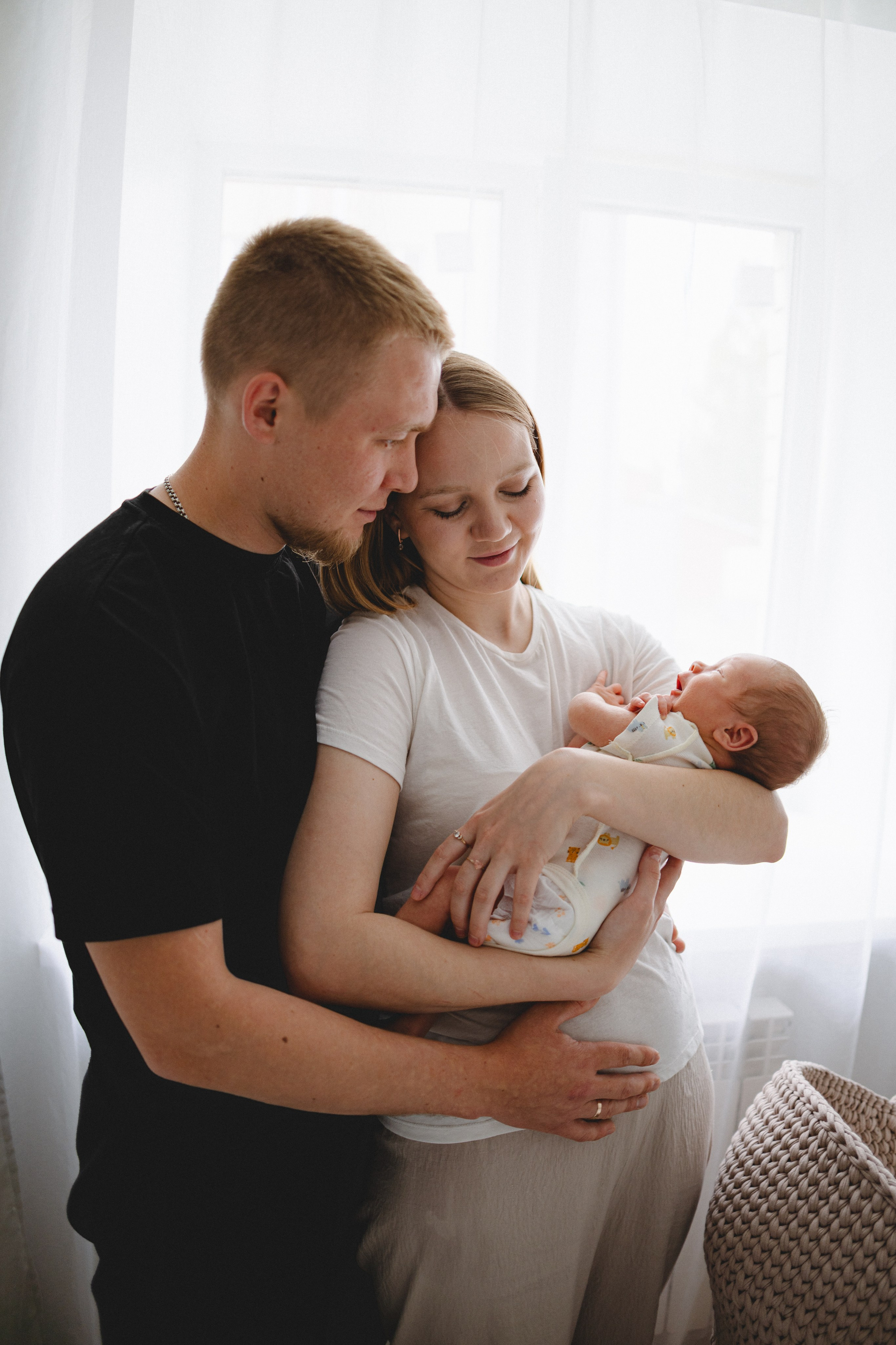 Young family sharing a quiet moment with their newborn