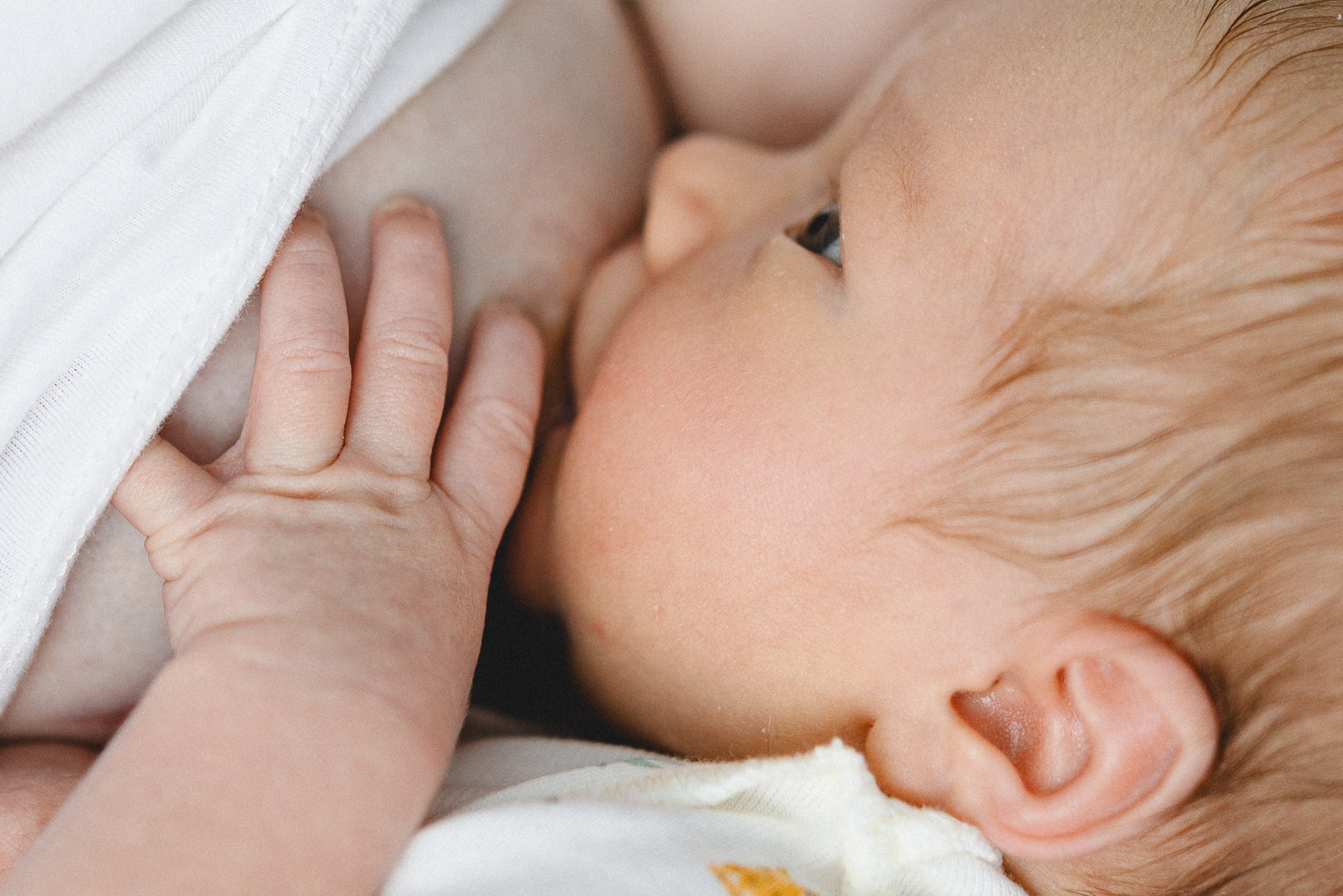 Close-up of a mother breastfeeding her newborn baby