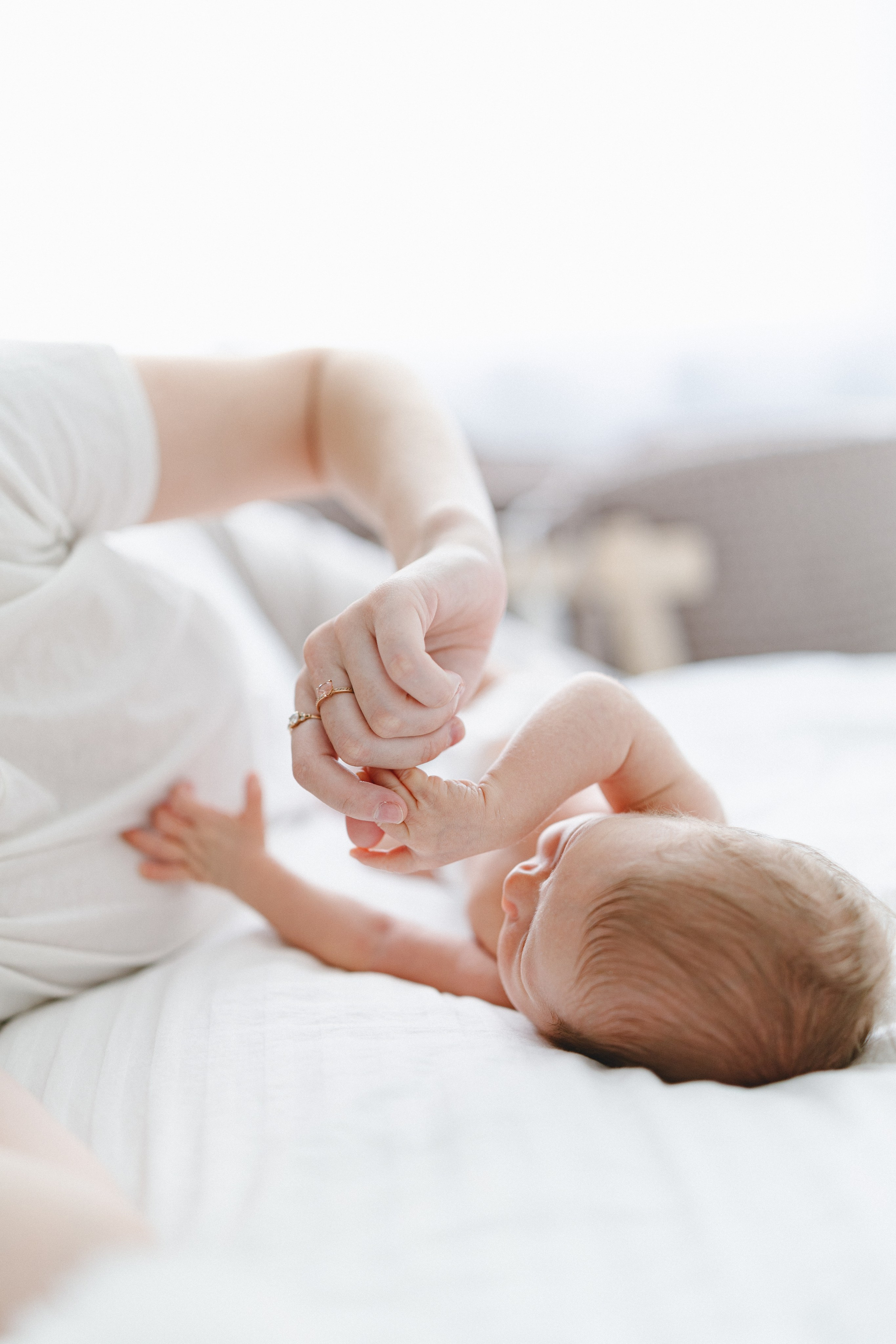 Mother gently holding her newborn’s tiny feet