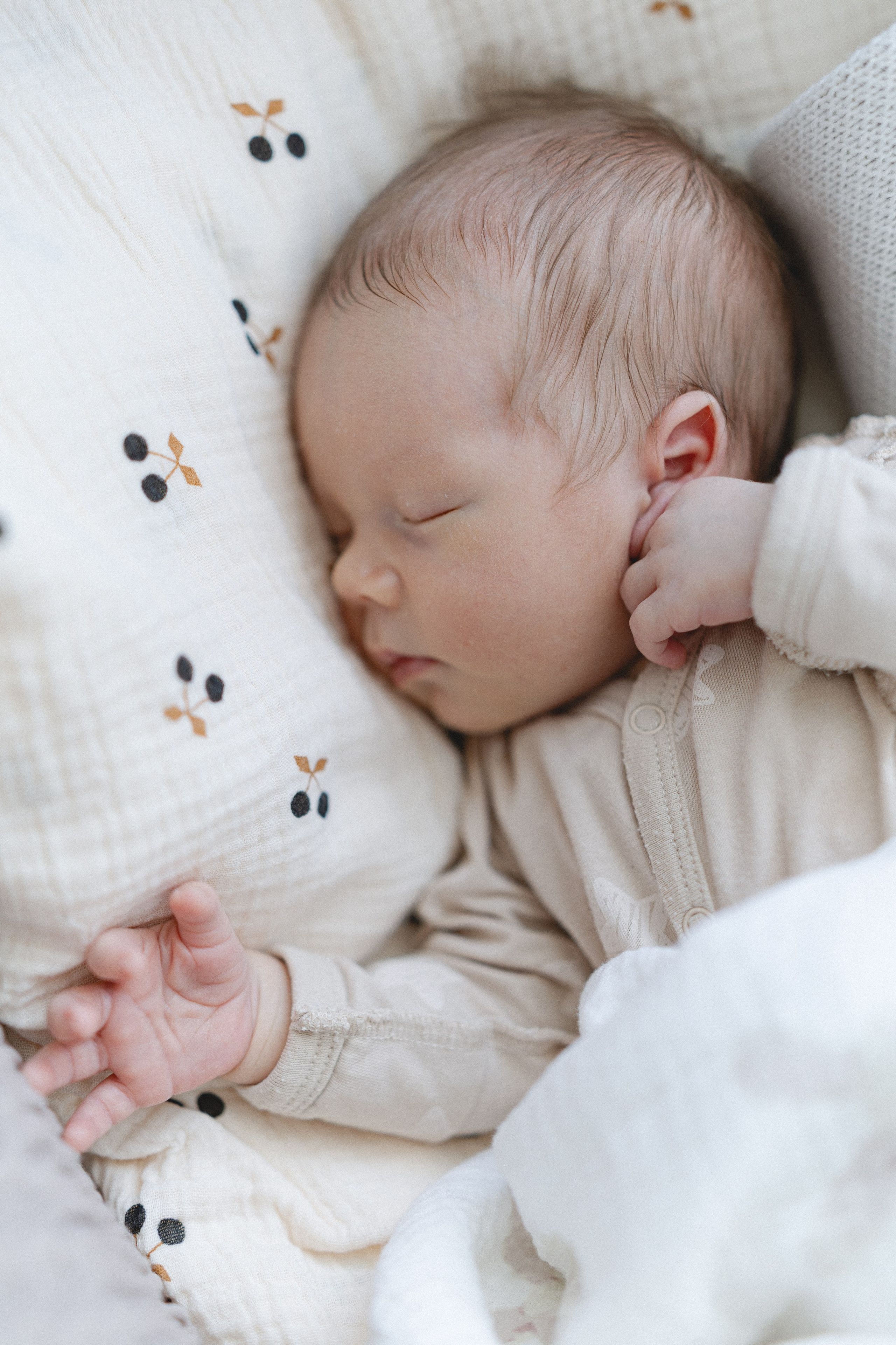 Sleeping newborn baby in a softly lit bedroom