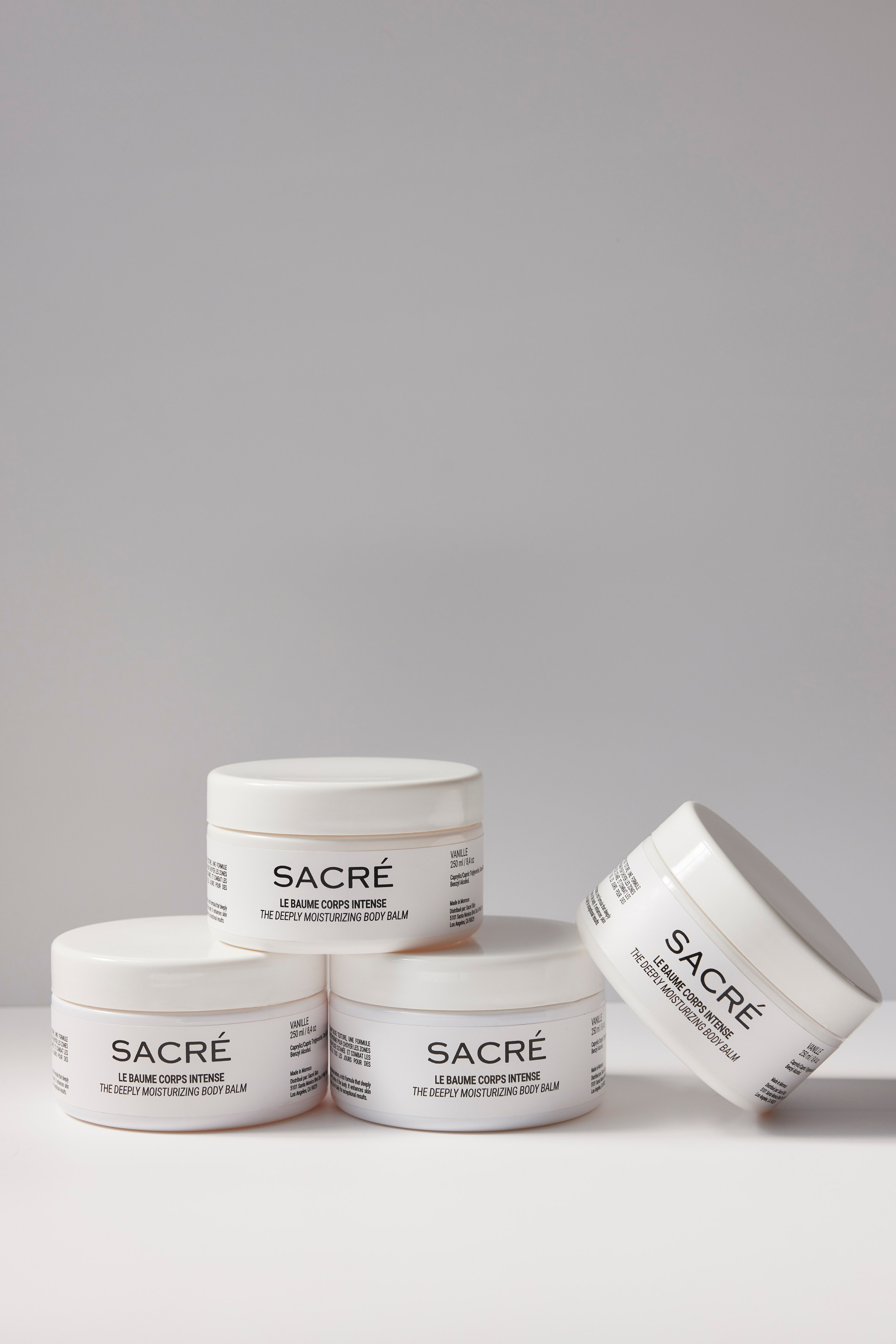 Stacked jars of premium skincare creams on a minimalist background, highlighting brand elegance.