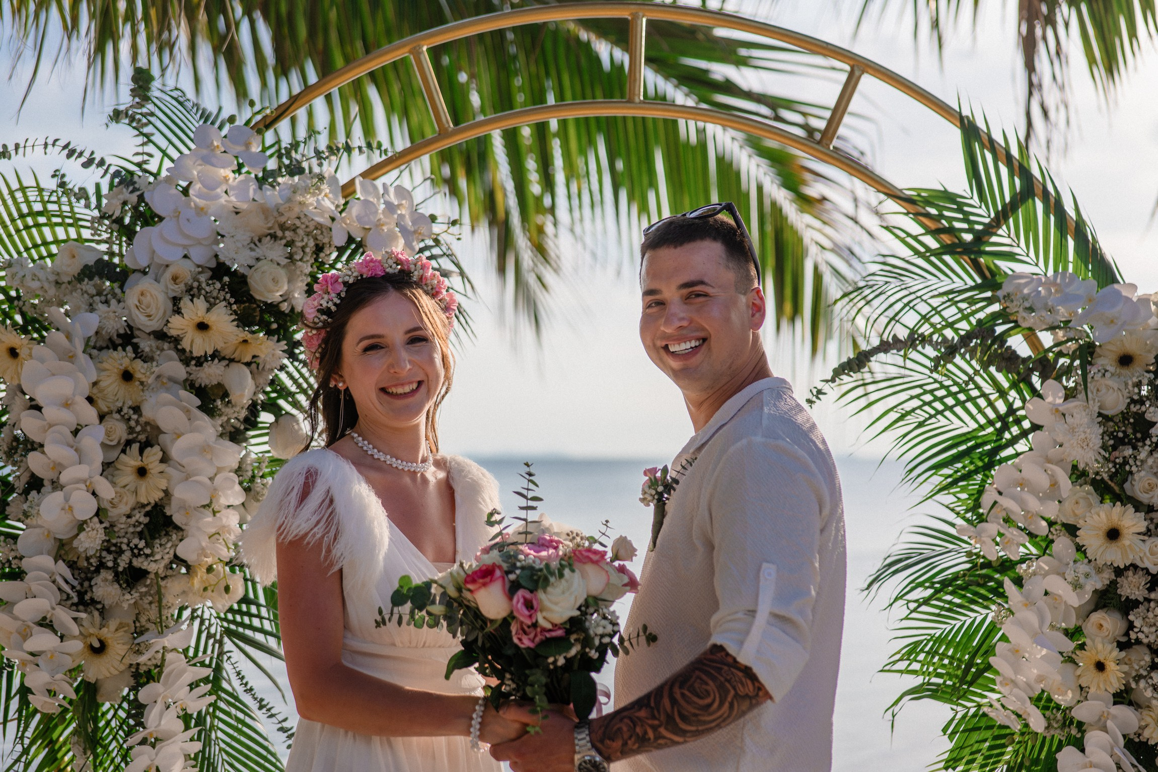 Bride and groom during a romantic beach wedding ceremony on Koh Samui, Thailand, surrounded by tropical scenery and ocean views