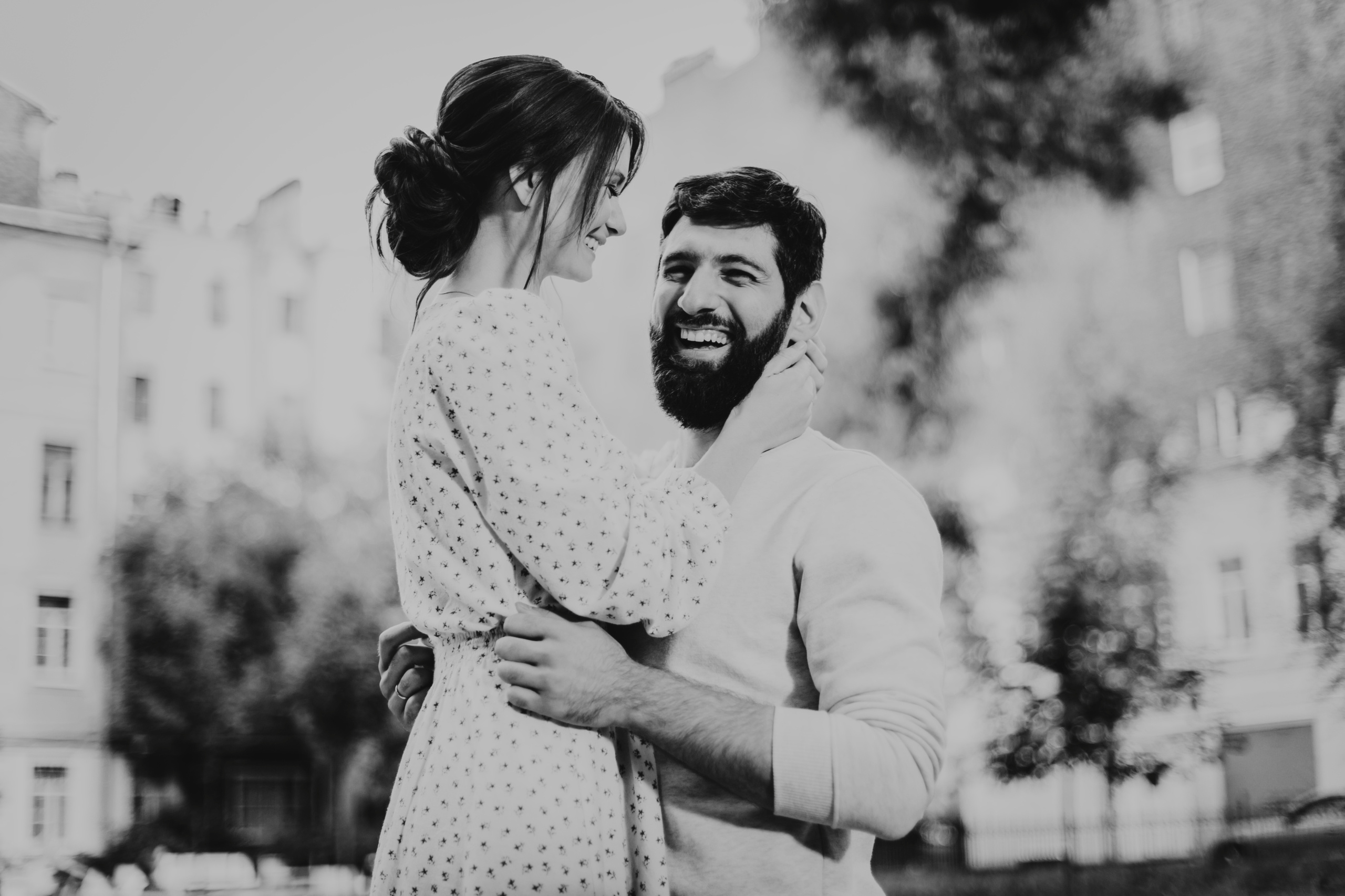 смеющиеся влюбленные обнимаются на улице Санкт-Петербурга