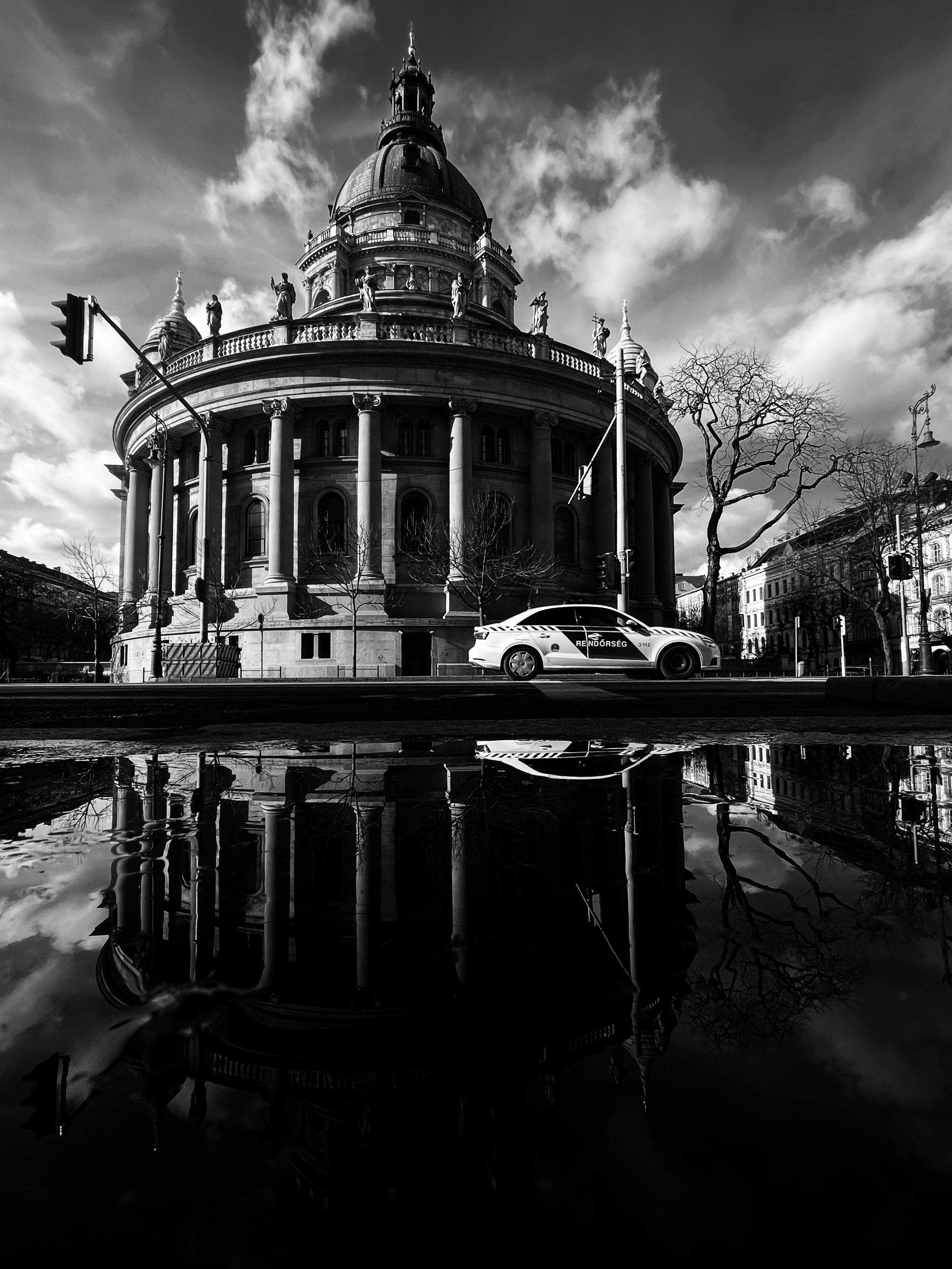 Reflection of the basilica in a puddle