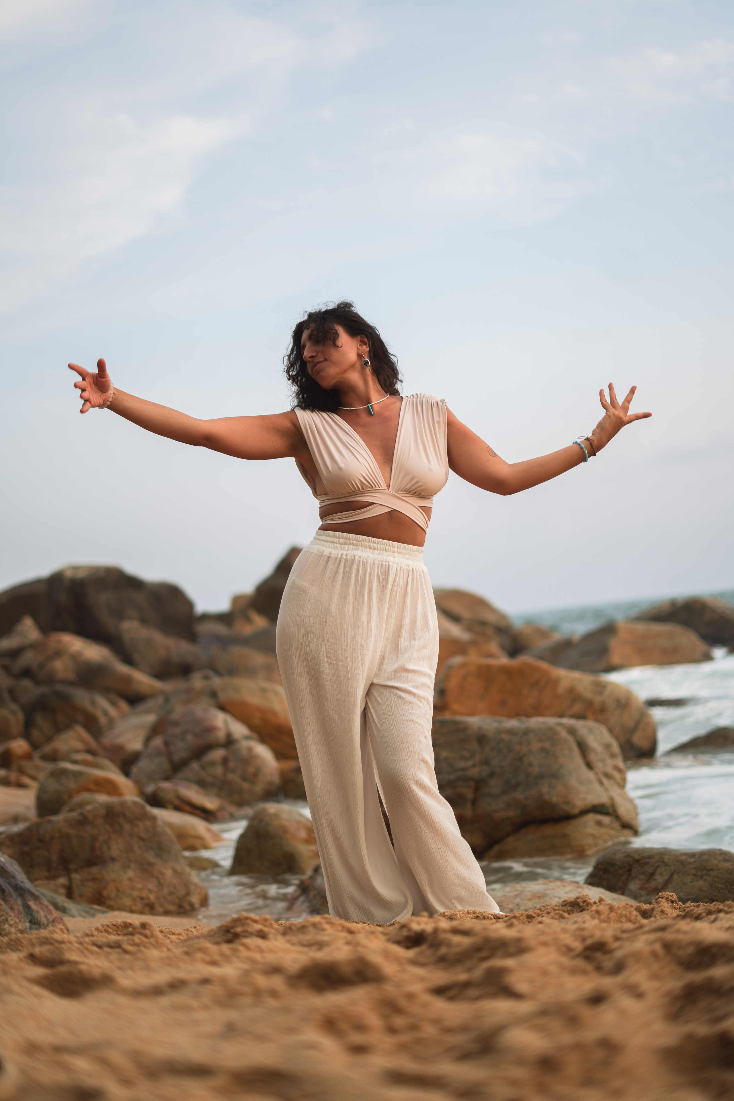 photoshoot of a beautiful brunette on a sandy beach by the Indian Ocean