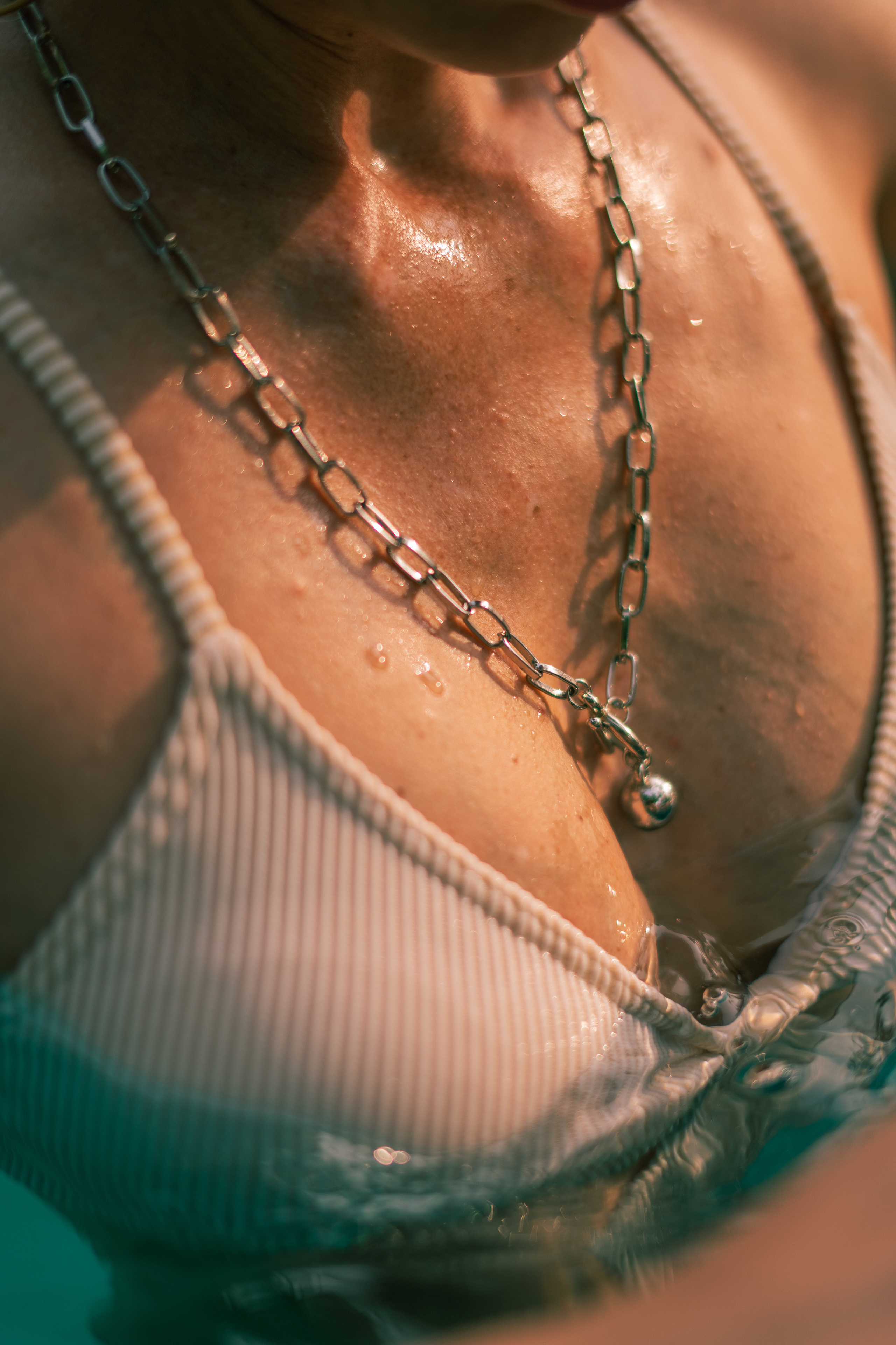 girl in a white swimsuit by the pool