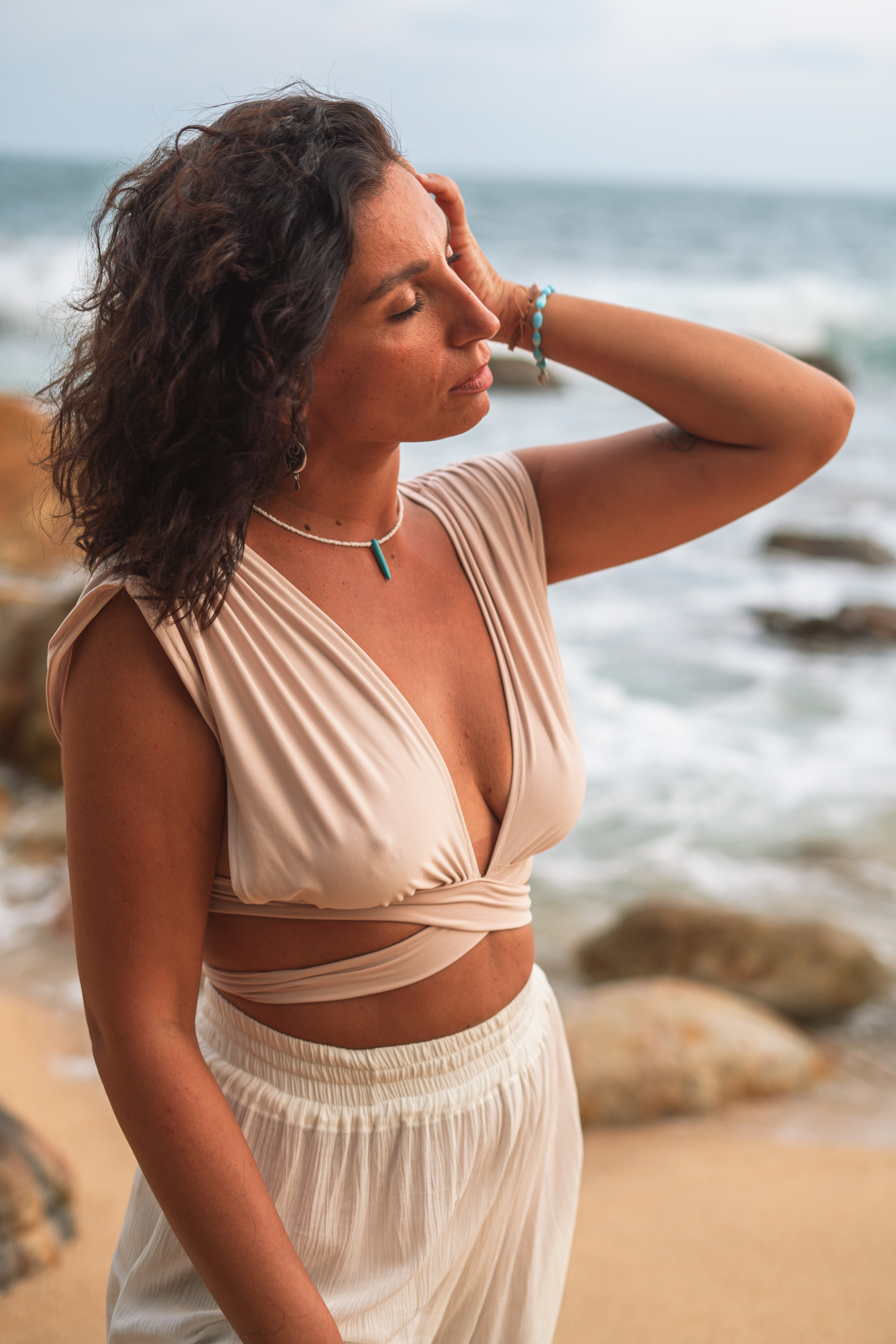 a brunette walking on the sandy beach of the Indian Ocean