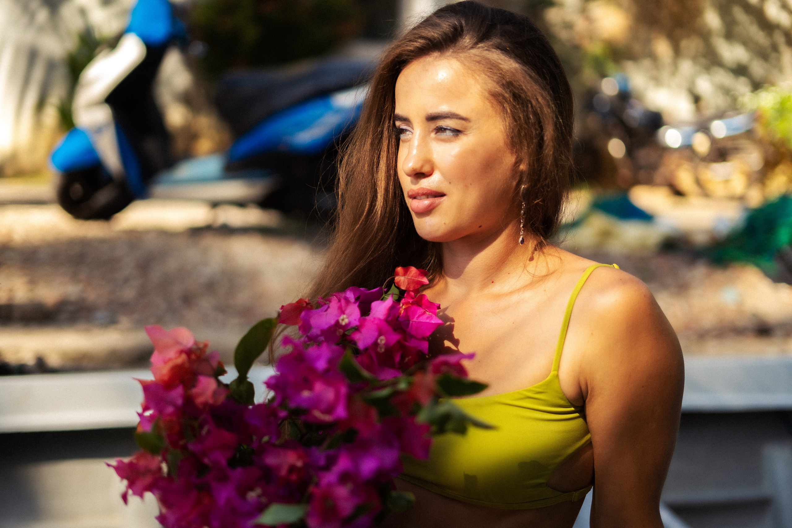 a girl with a bouquet on a boat against the backdrop of ocean waves