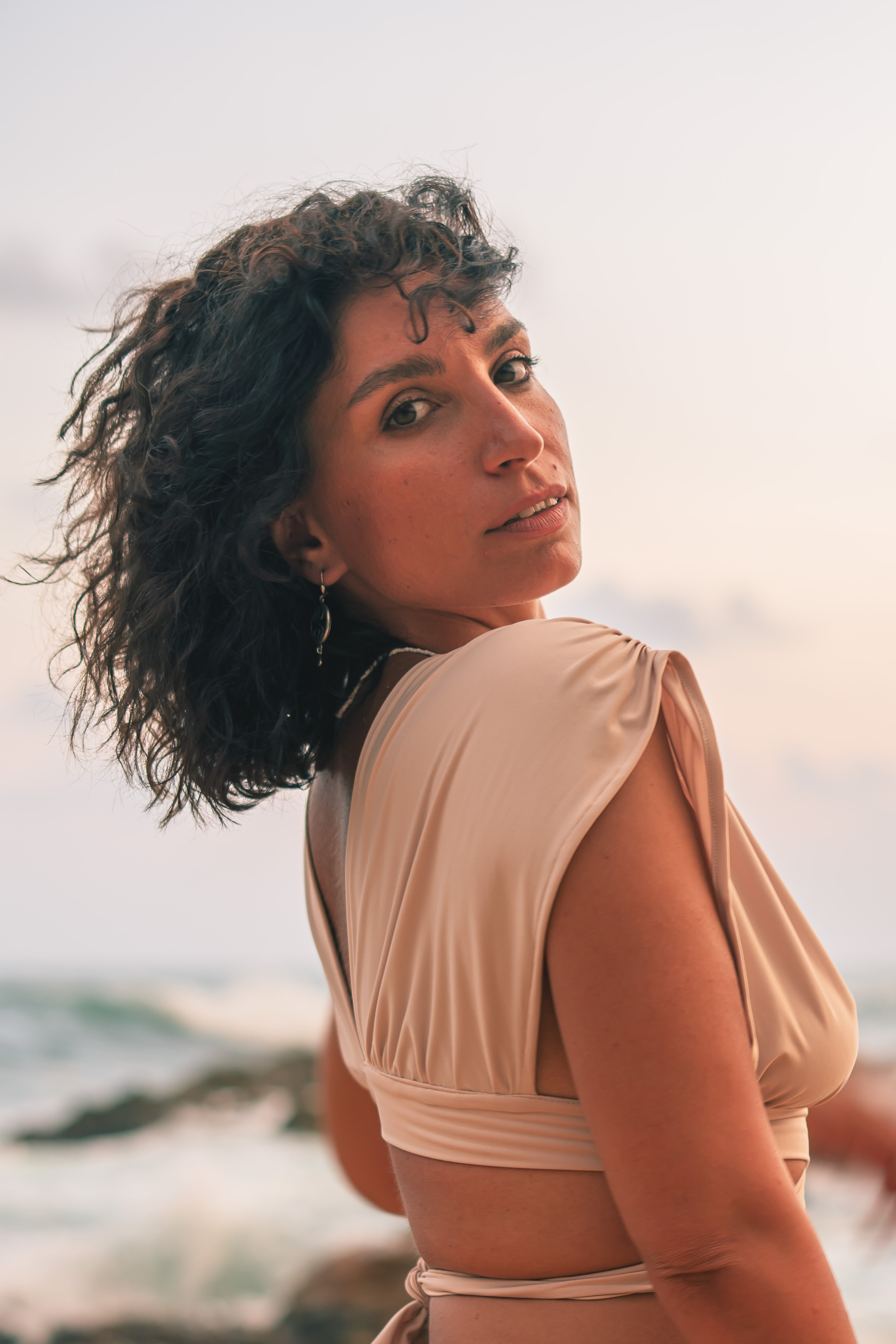 a beautiful brunette with flowing hair on the beach of the Indian Ocean