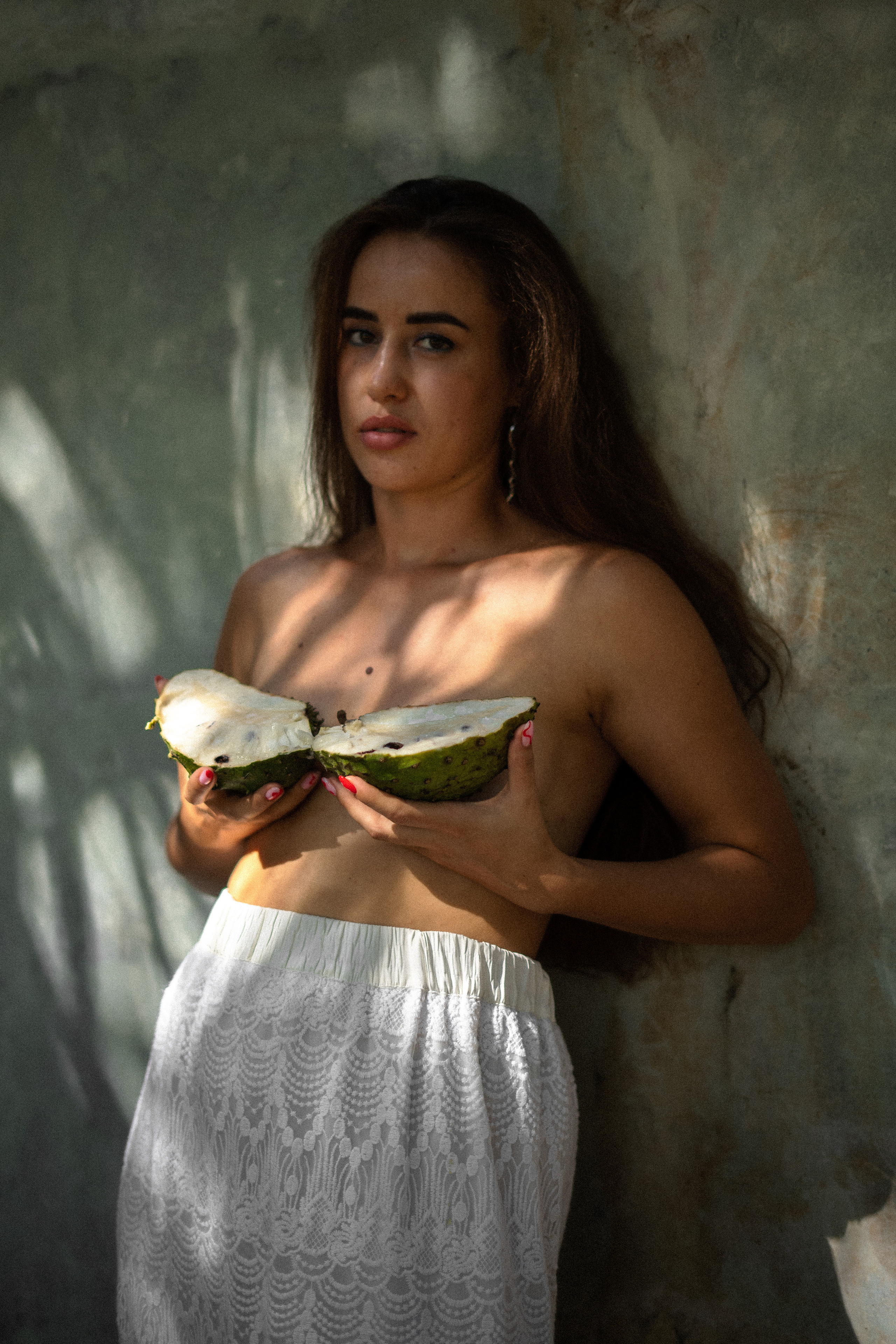 photoshoot of a partially nude girl with watermelons