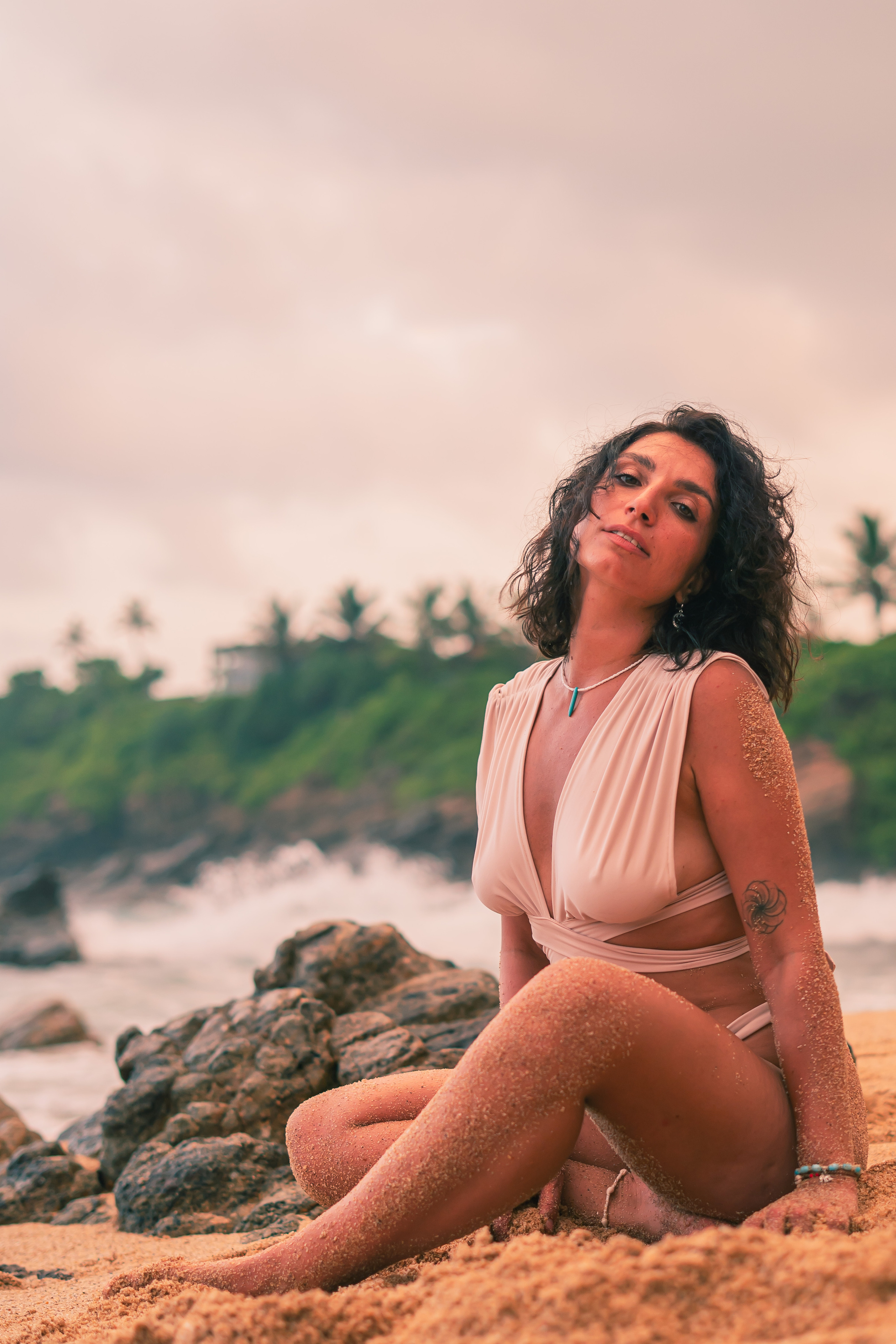 a brunette taking steps along the sandy shore of the Indian Ocean