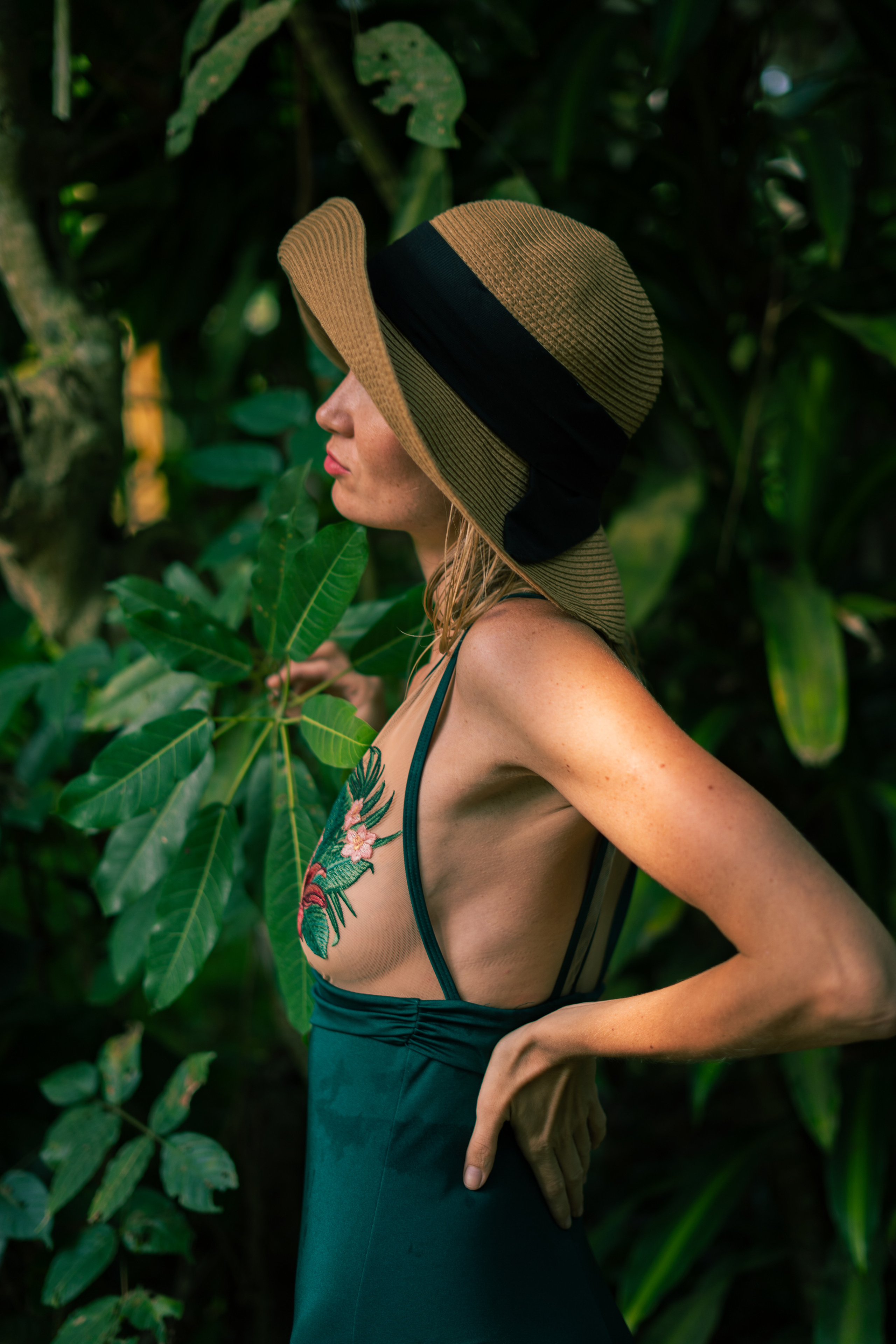 photoshoot of a girl in a green swimsuit in the jungle