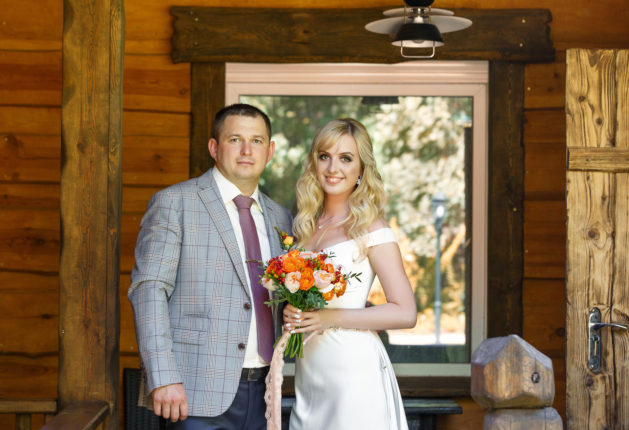 жених с невестой стоят рядом и смотрят на вас.