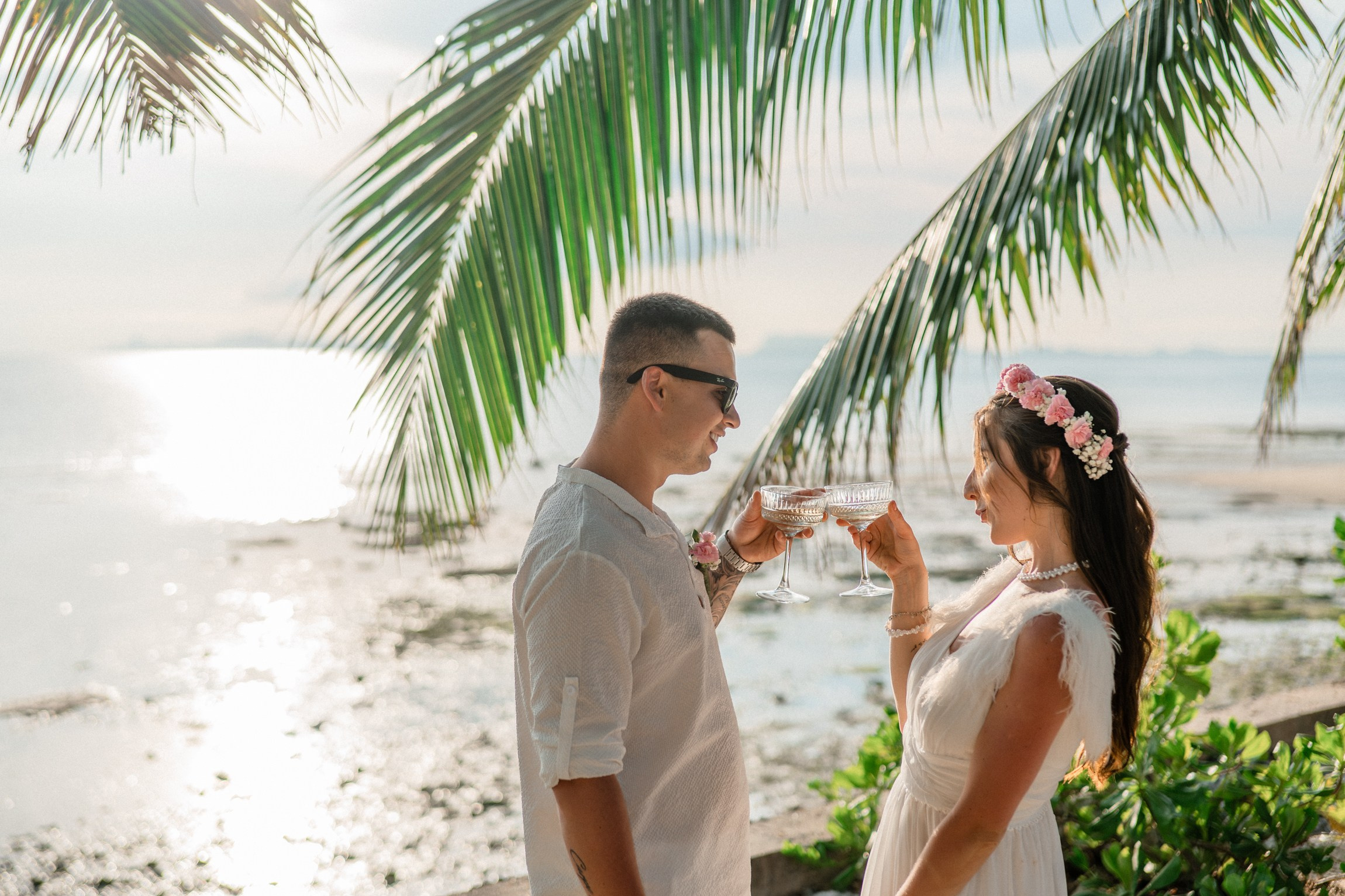 Bride and groom during a romantic beach wedding ceremony on Koh Samui, Thailand, surrounded by tropical scenery and ocean views