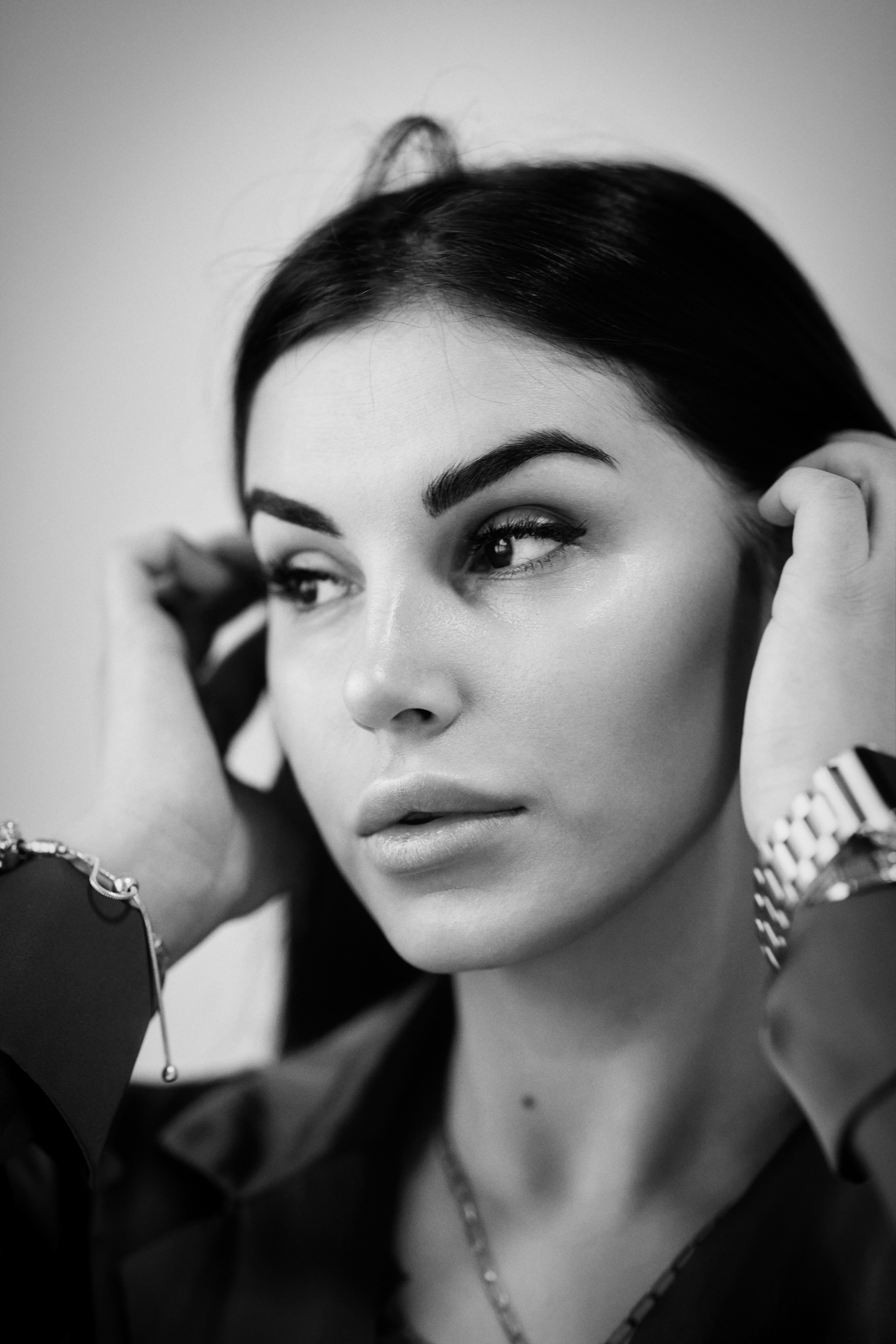 На светлом фоне студии темноволосая Карина в костюме выглядит сильной и независимой женщиной.