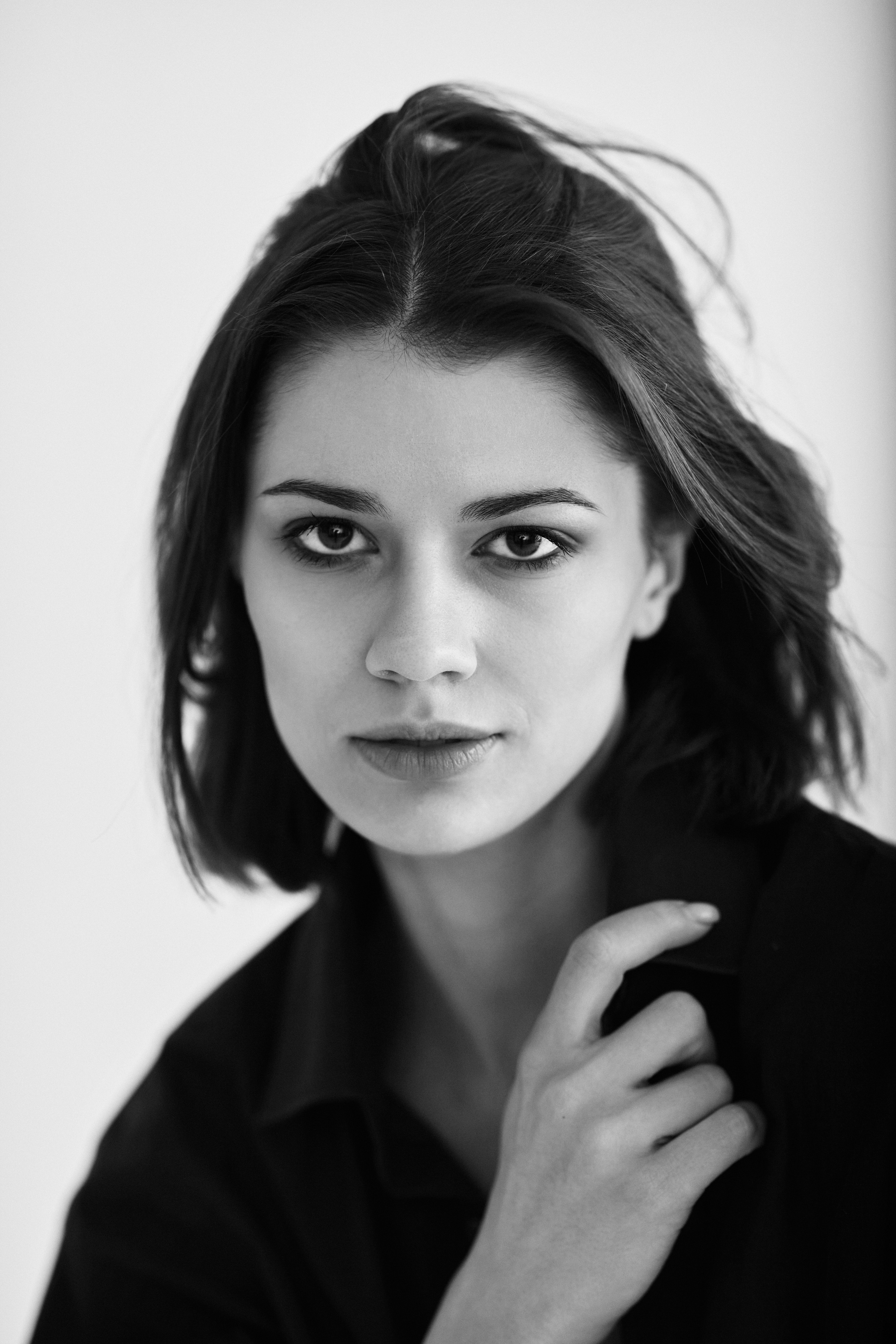 Темноволосая красавица Софья Мисс Тула — 2020 на светлом фоне в темном платье, создает загадочную атмосферу