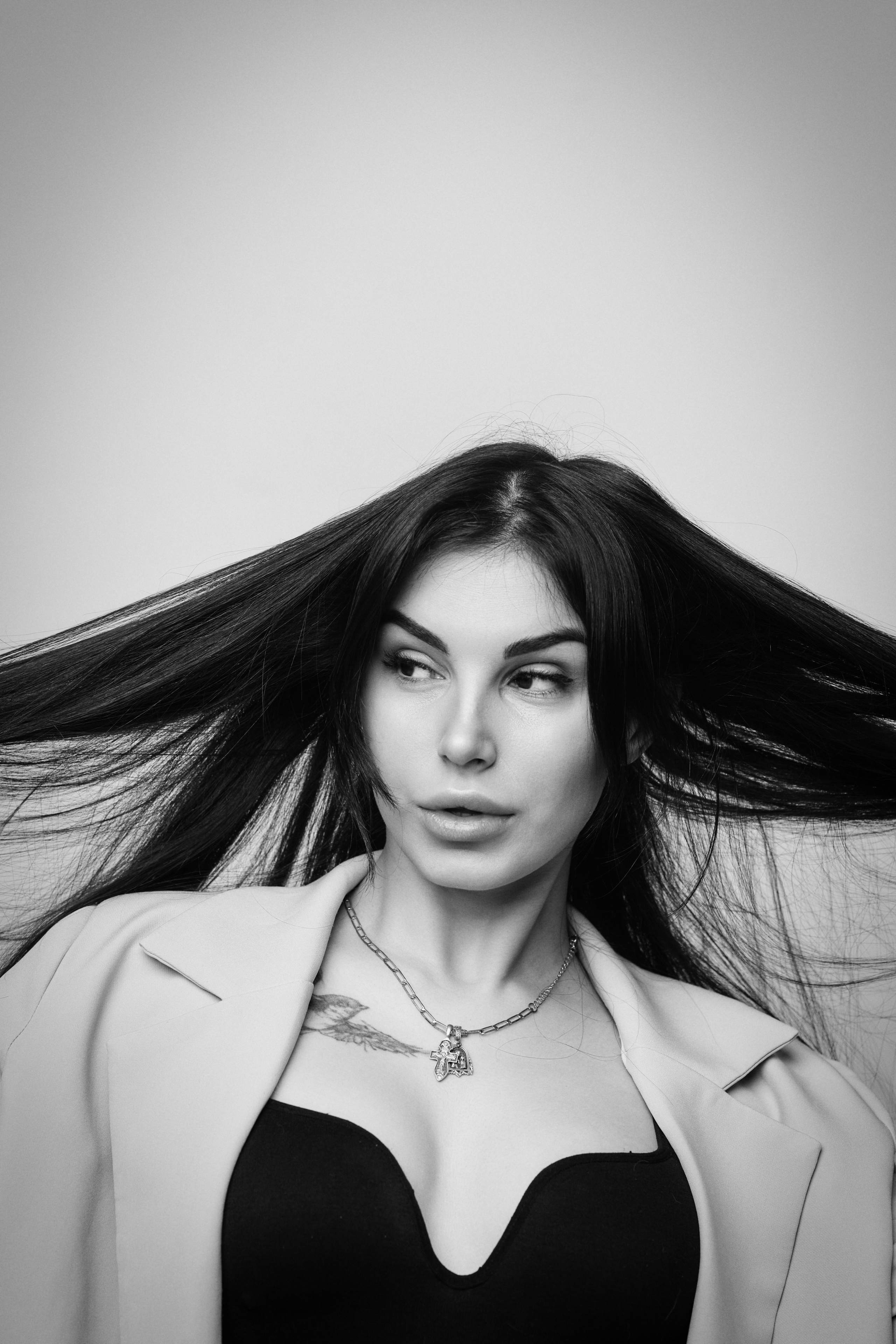 Карина в костюме на светлом фоне: элегантная фотосессия в студии