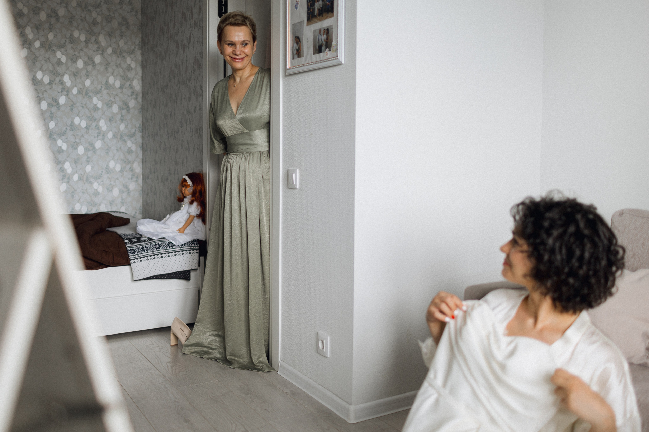 Ностальгия и эстафета поколений: невеста в свадебном платье на паркете, кукла в аналогичном наряде на кровати и мама, застывшая в дверном проеме