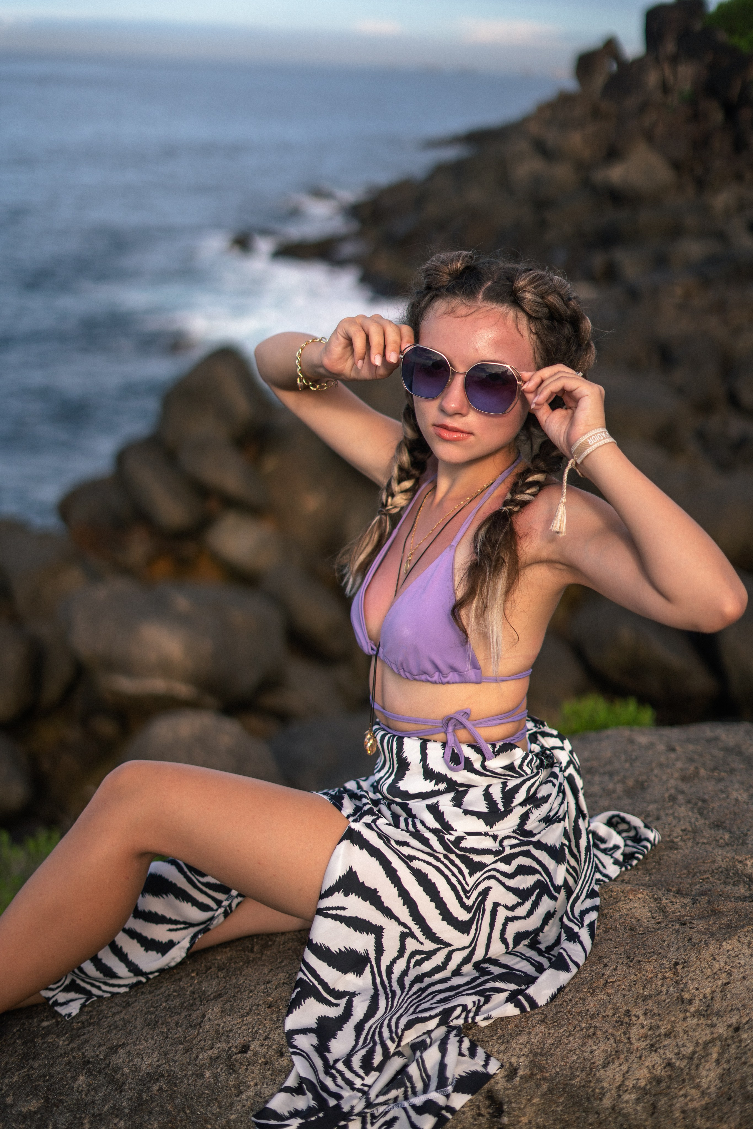 a young girl in a purple swimsuit against the backdrop of the vast ocean