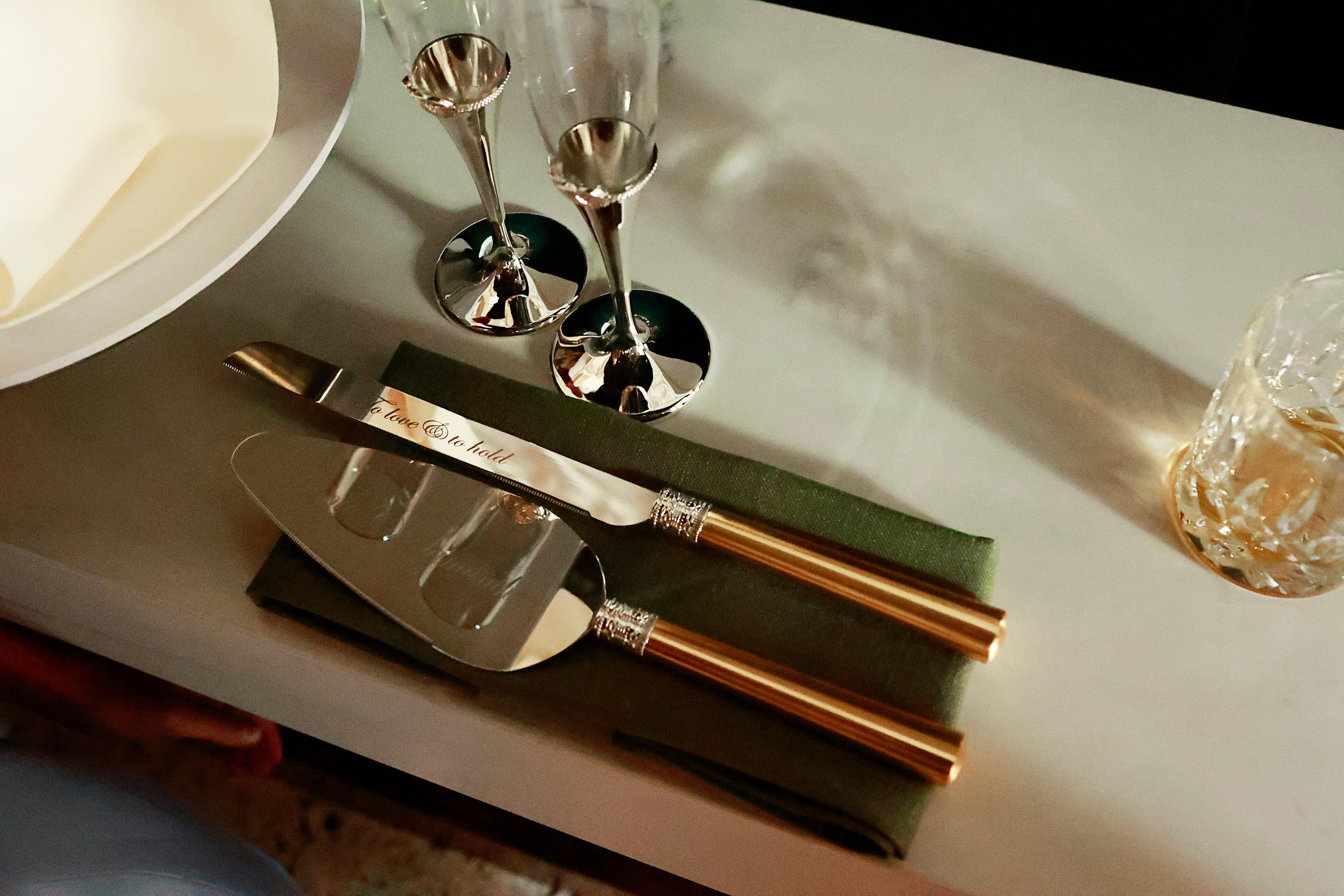 Luxury table setting detail with gold cutlery and crystal glassware styled for hospitality branding and commercial event photography in Sydney