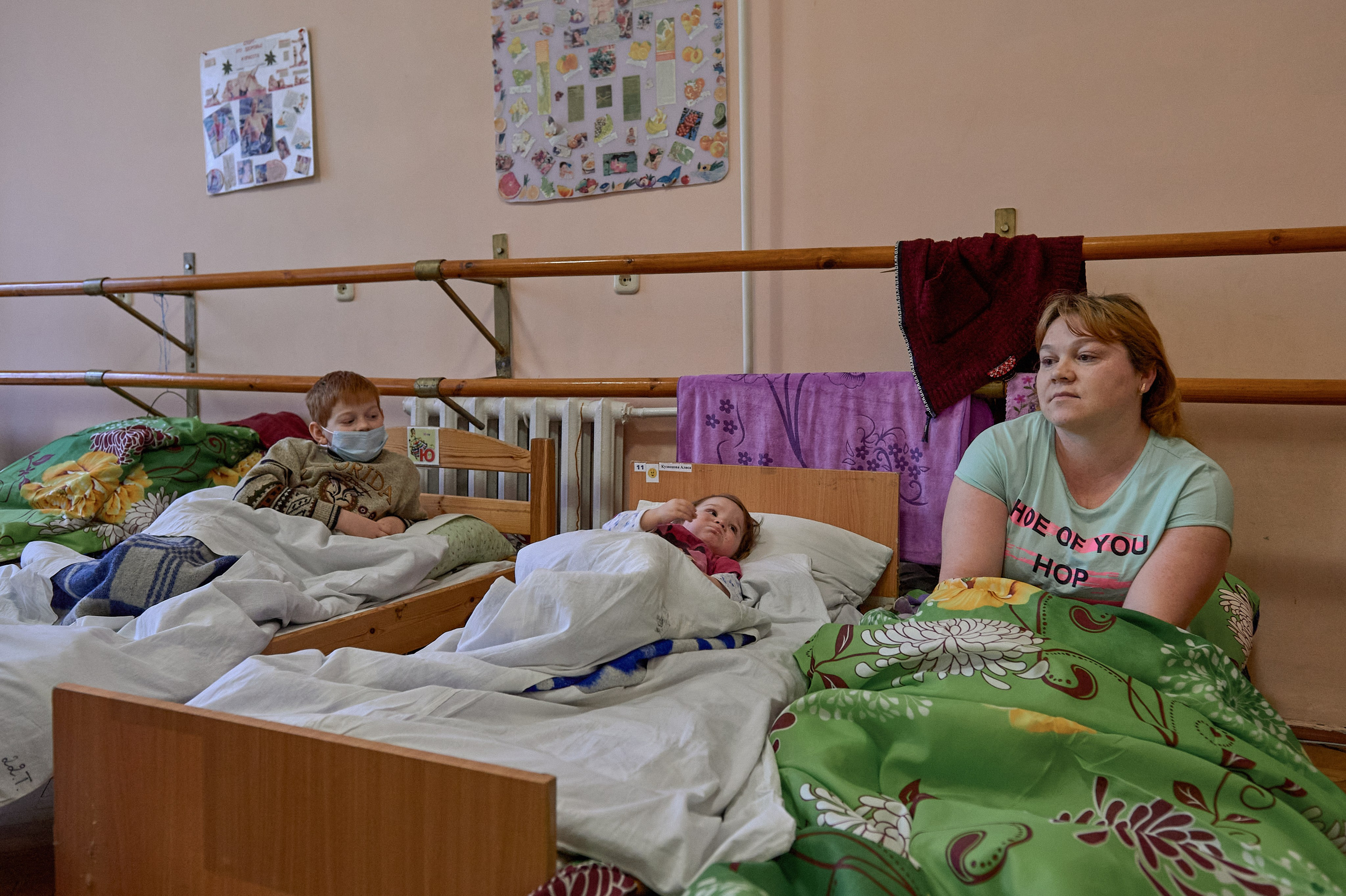 A woman with children in a temporary refugee accommodation center set up in a dance studio of the rural cultural center in the village of Krasnogornyatsky, Rostov region, February 26, 2022.
