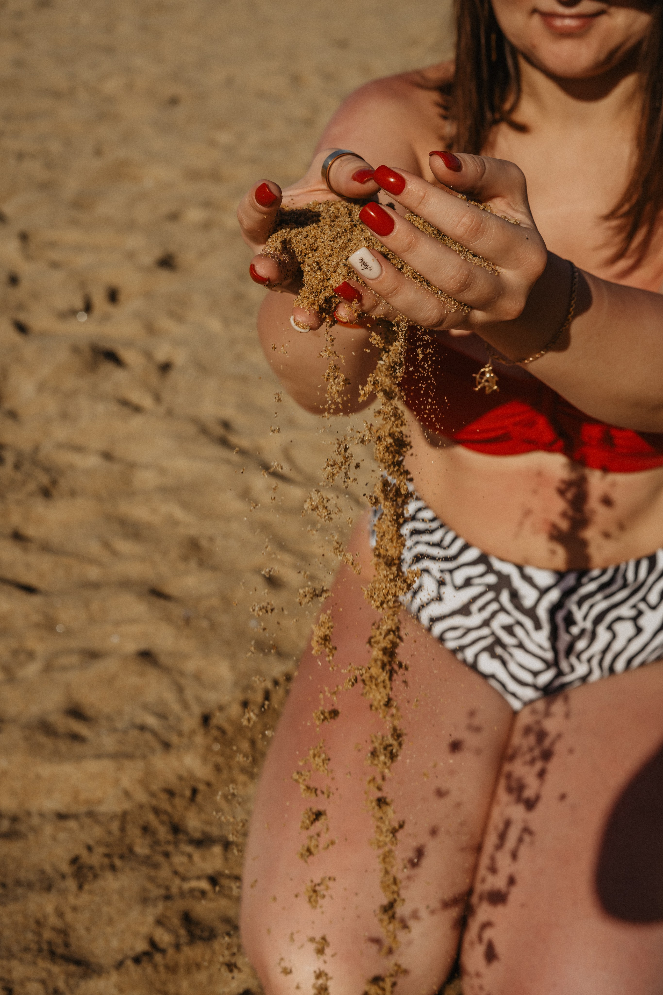 a girl in a straw hat and summer dress on the beach