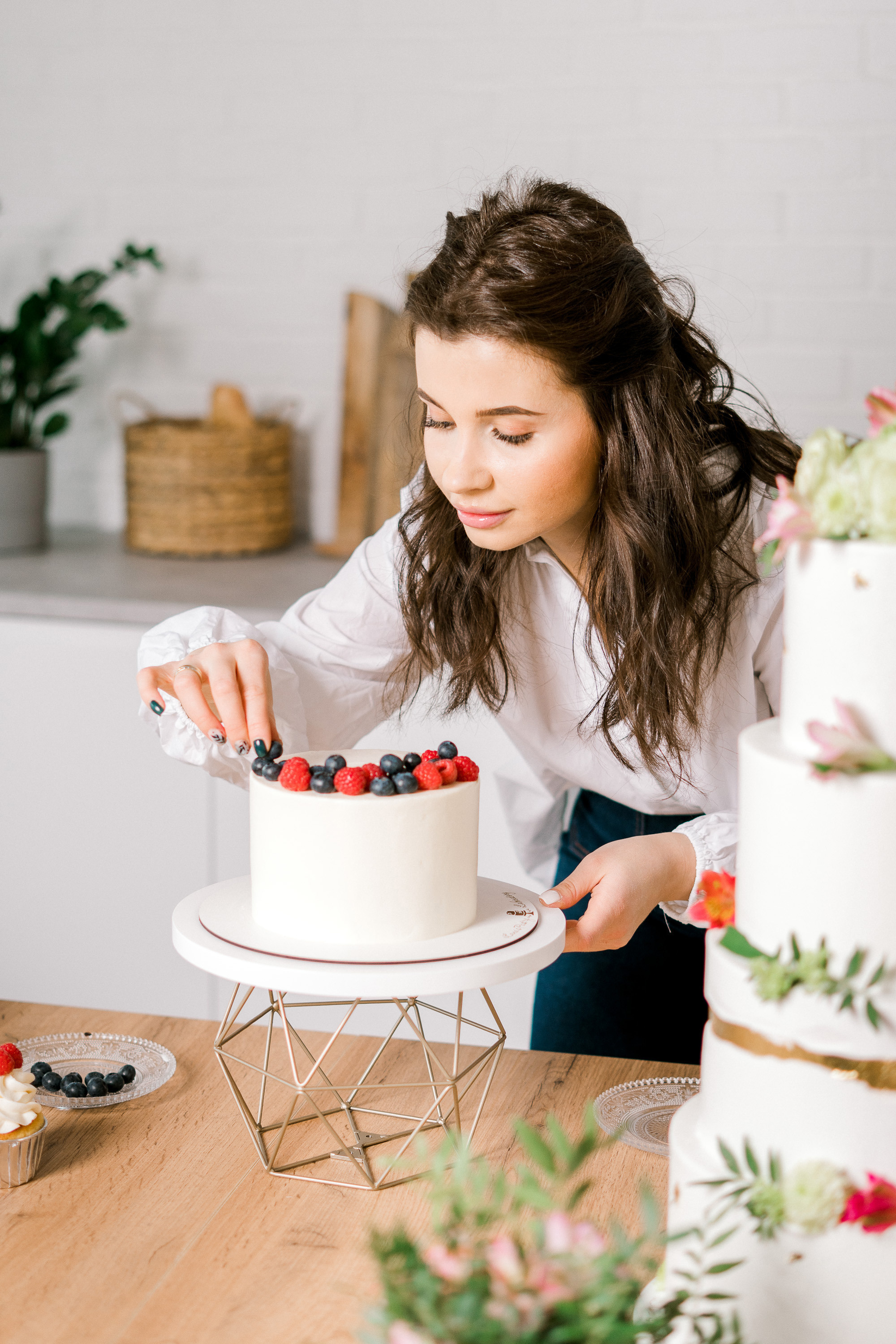 Девушка домашний кондитер за работой украшает торт