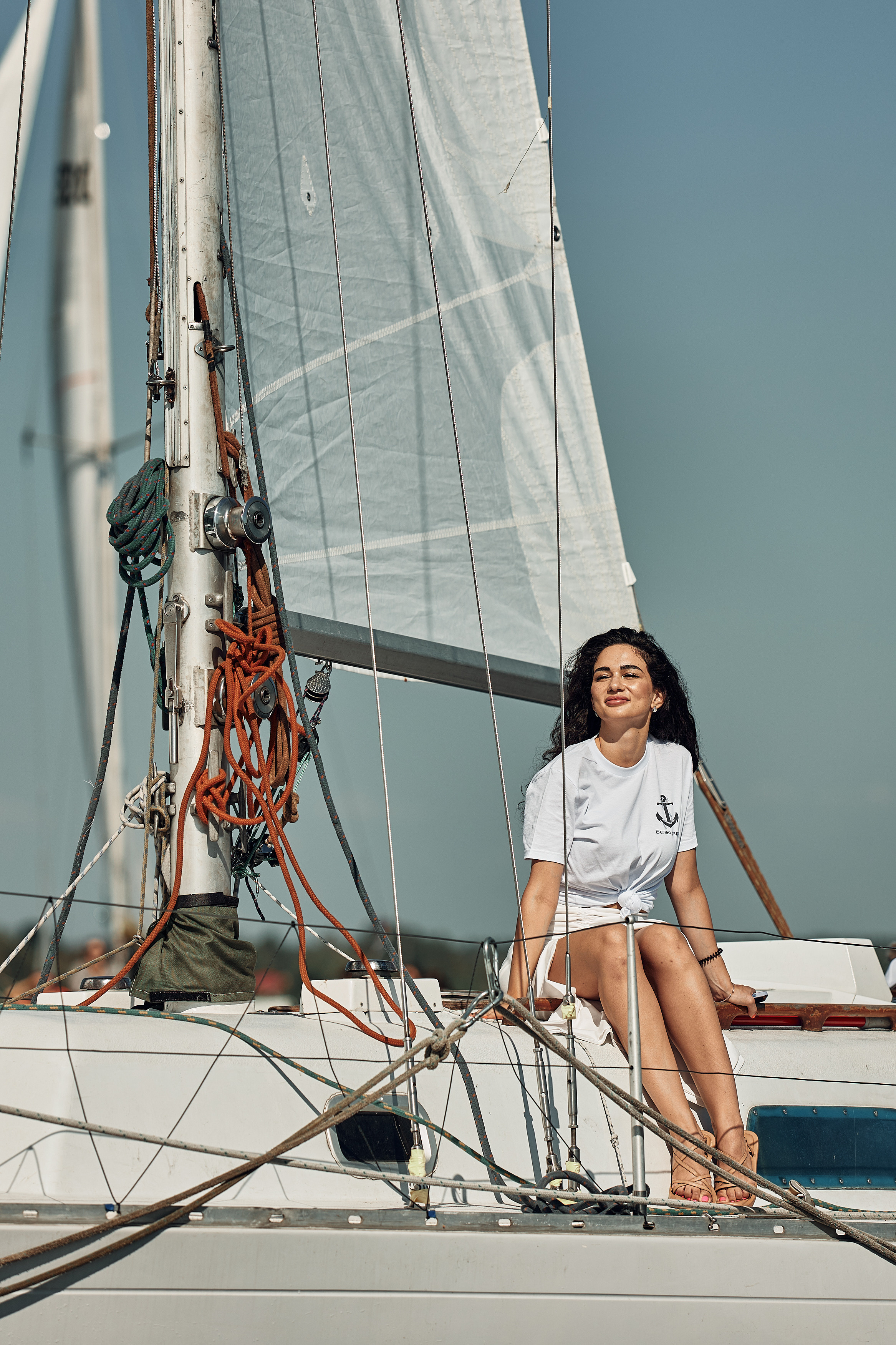 Молодая девушка на парусной лодке