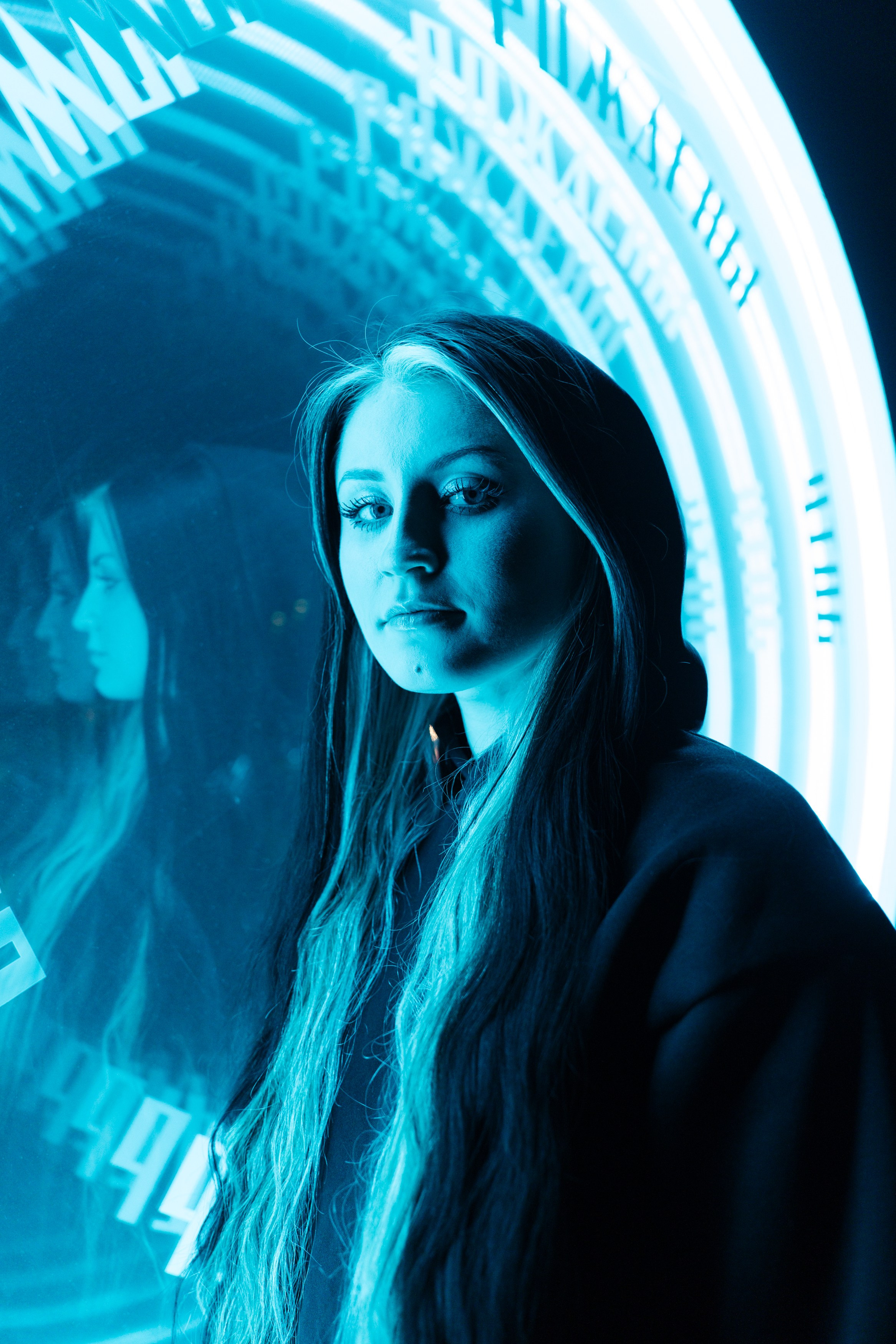 фотография молодой девушки в лучах голубого неонового света