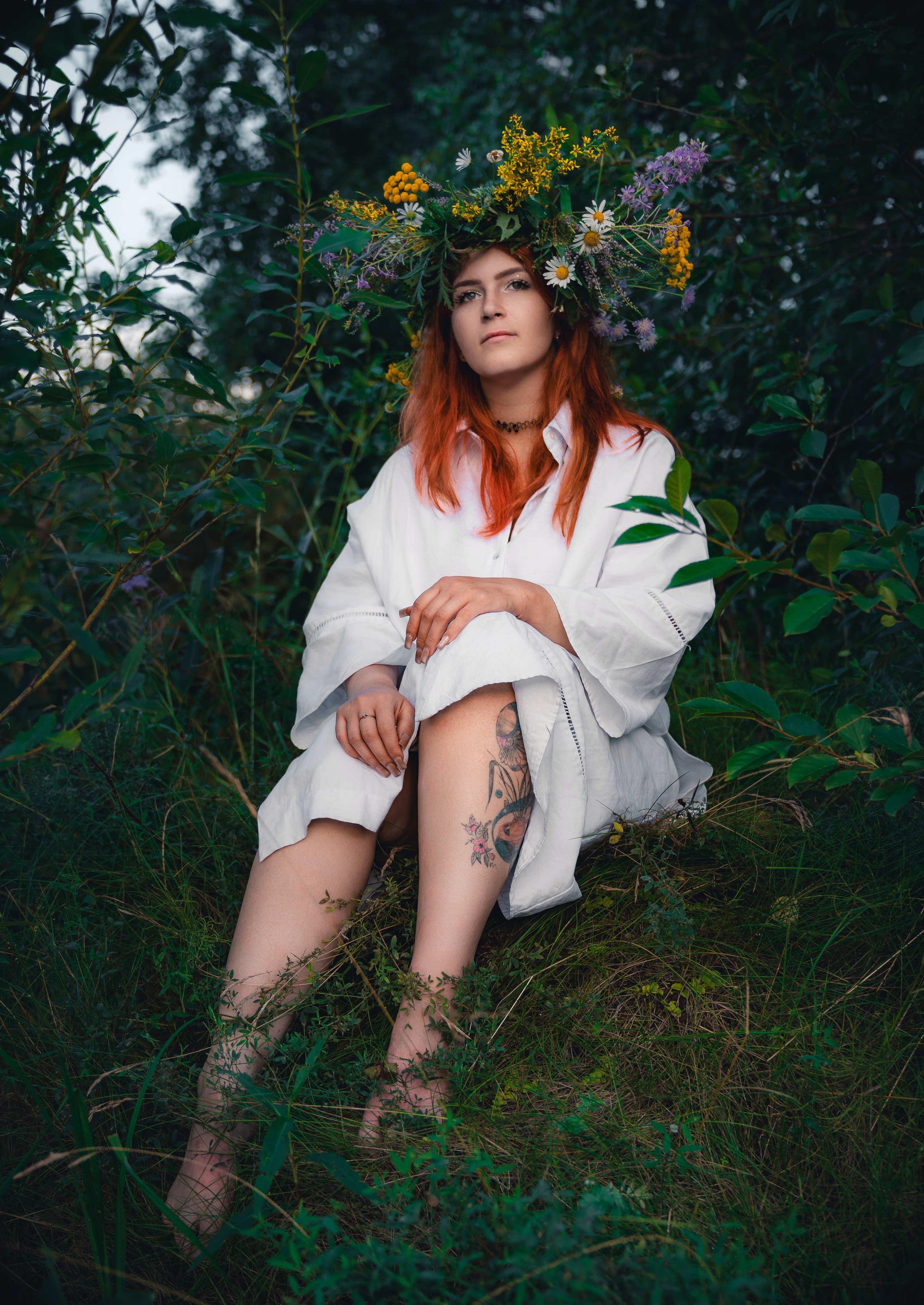 Прогулочная фотосессия в высокой траве: портрет рыжеволосой модели с цветочным венком из ромашек и тысячелистника, естественный свет.