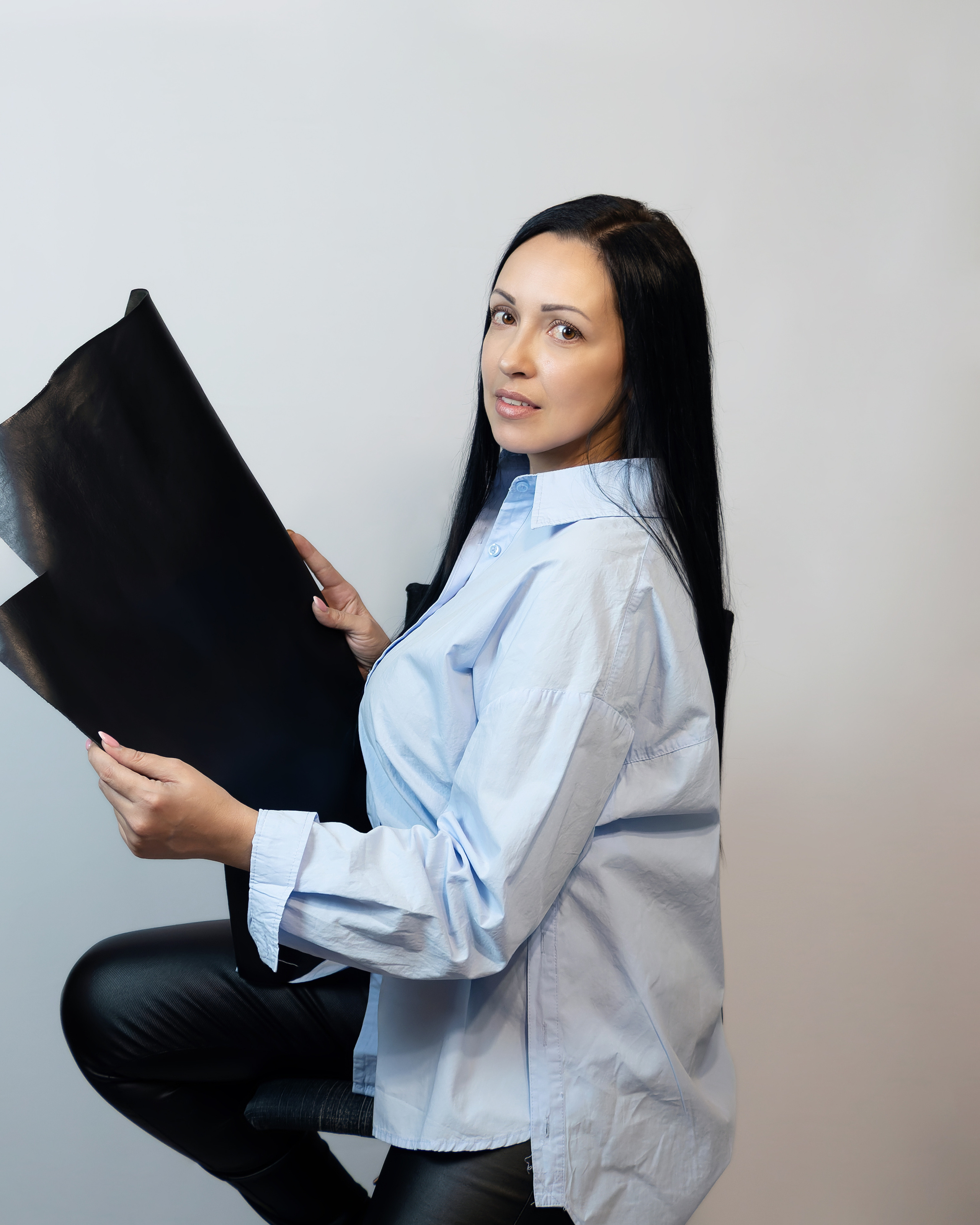 Фото девушки с кожей в руках на белом фоне