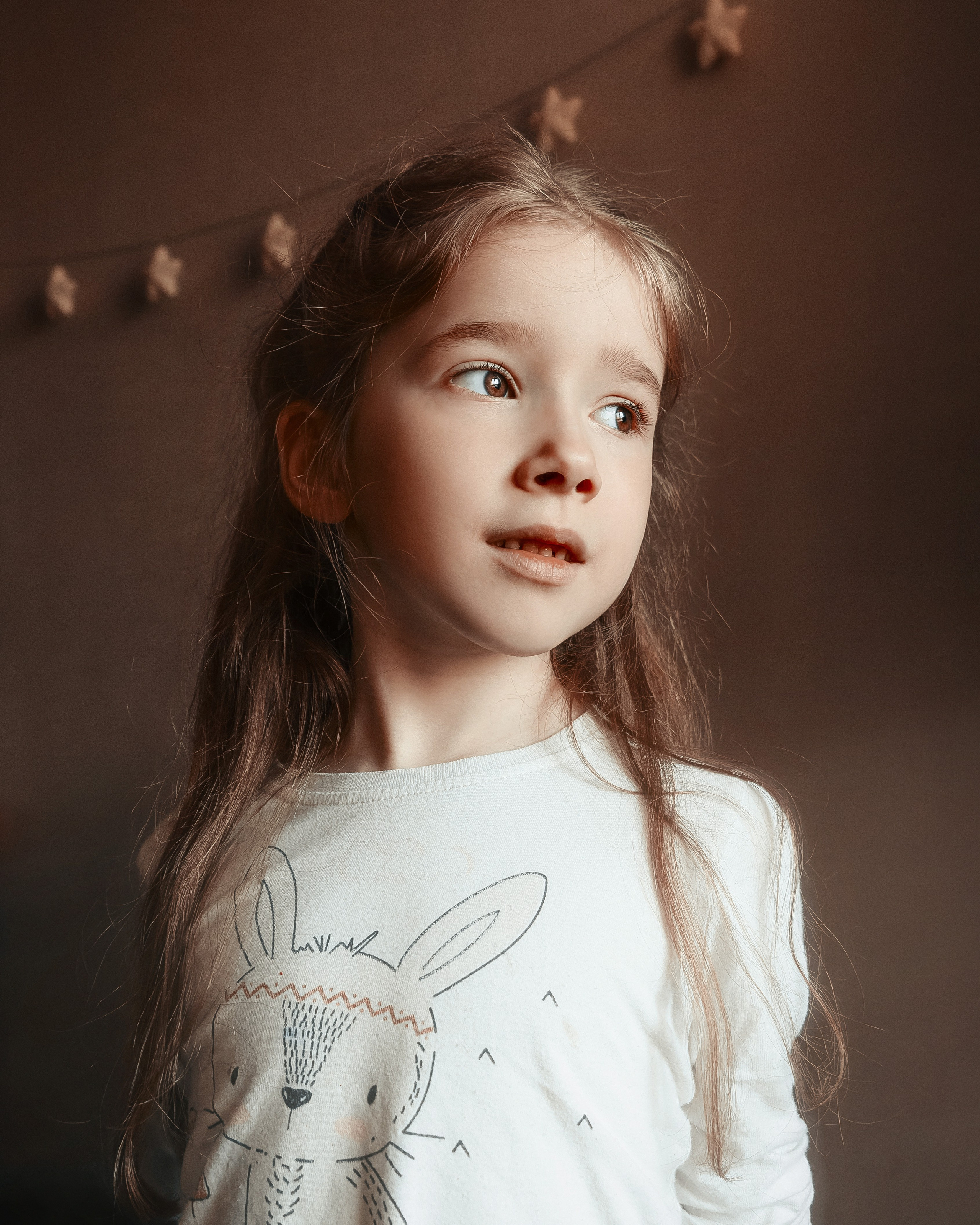 Портрет девочки в комнате в ярком мягком свете