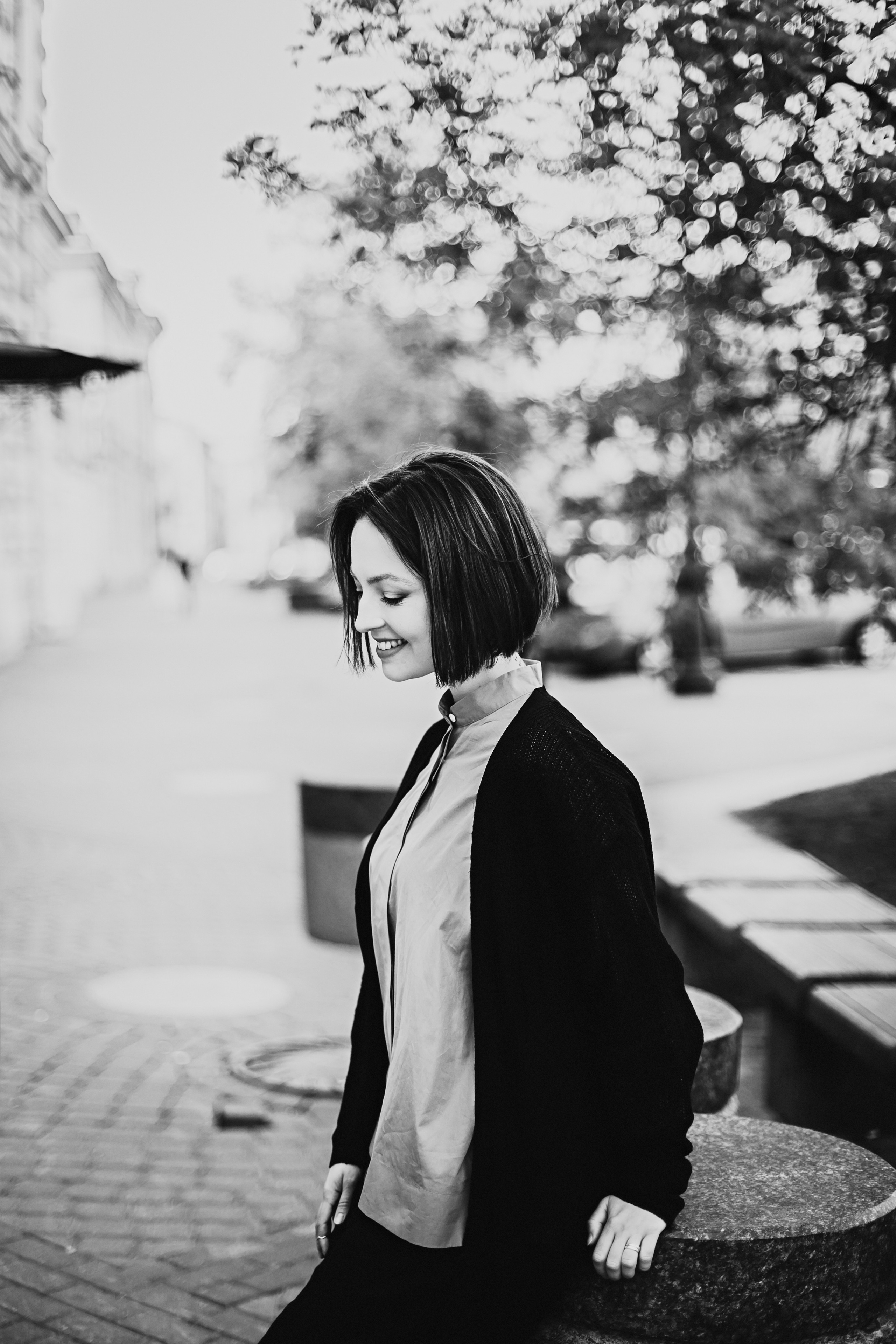 поясной чёрно-белый уличный портер улыбающейся девушки