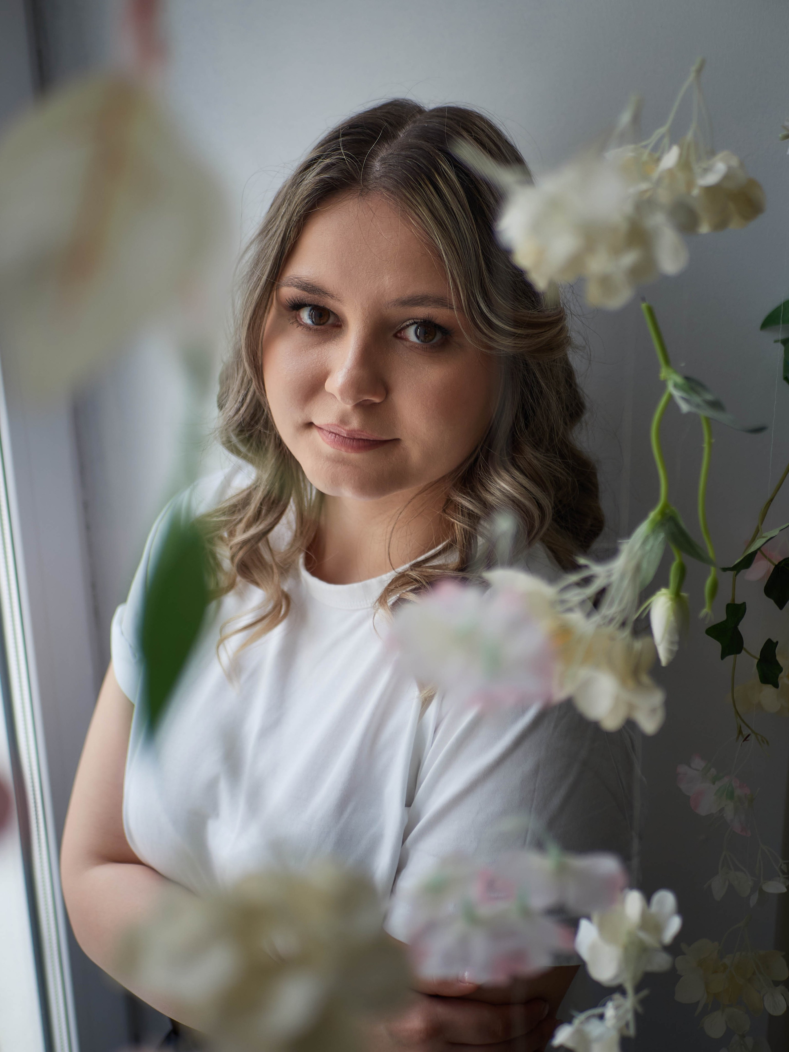 Бизнес фотосессия в студии с цветами в Самаре: девушка в белой майке.