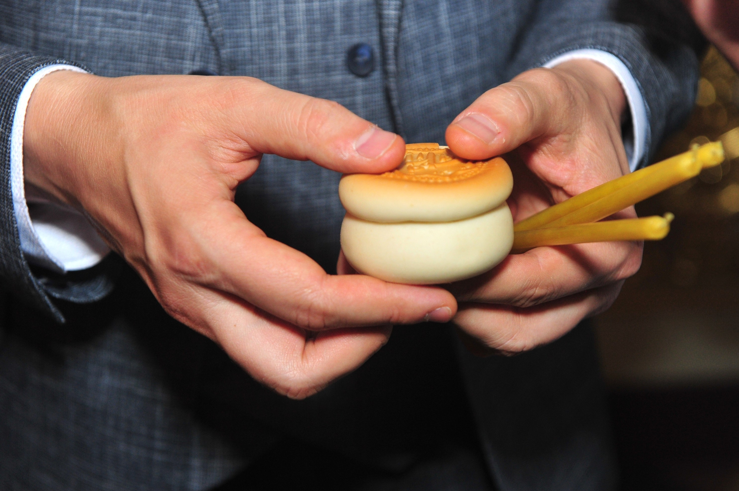 Свадьба на Воробьёвых Горах в храме рядом с МГУ, жених держит в руках просвирку и свечку